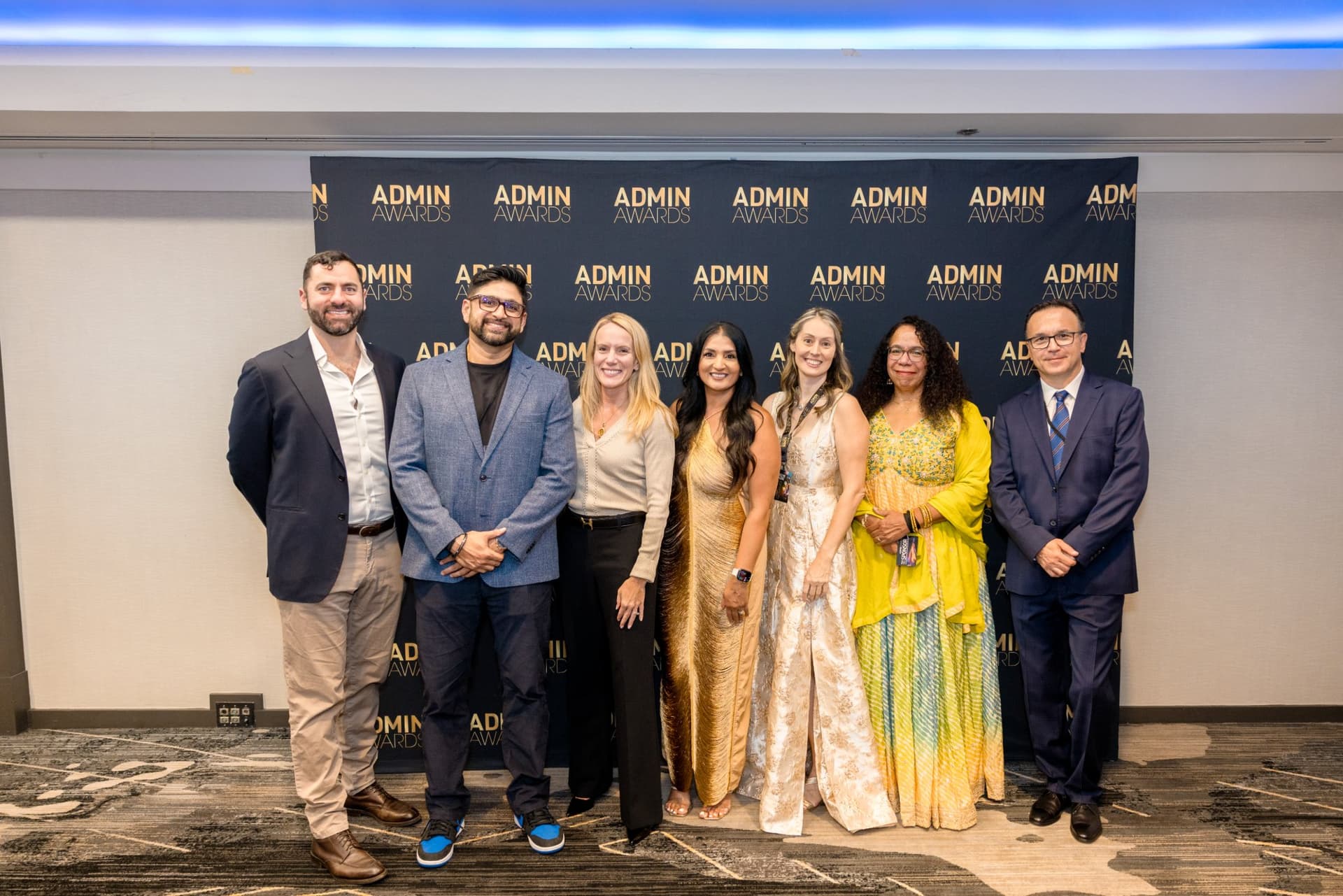 Group of guests posing in front of the Admin Awards step-and-repeat at Admin Awards 2026 at SFO Marriott Waterfront, Burlingame by JY Studio