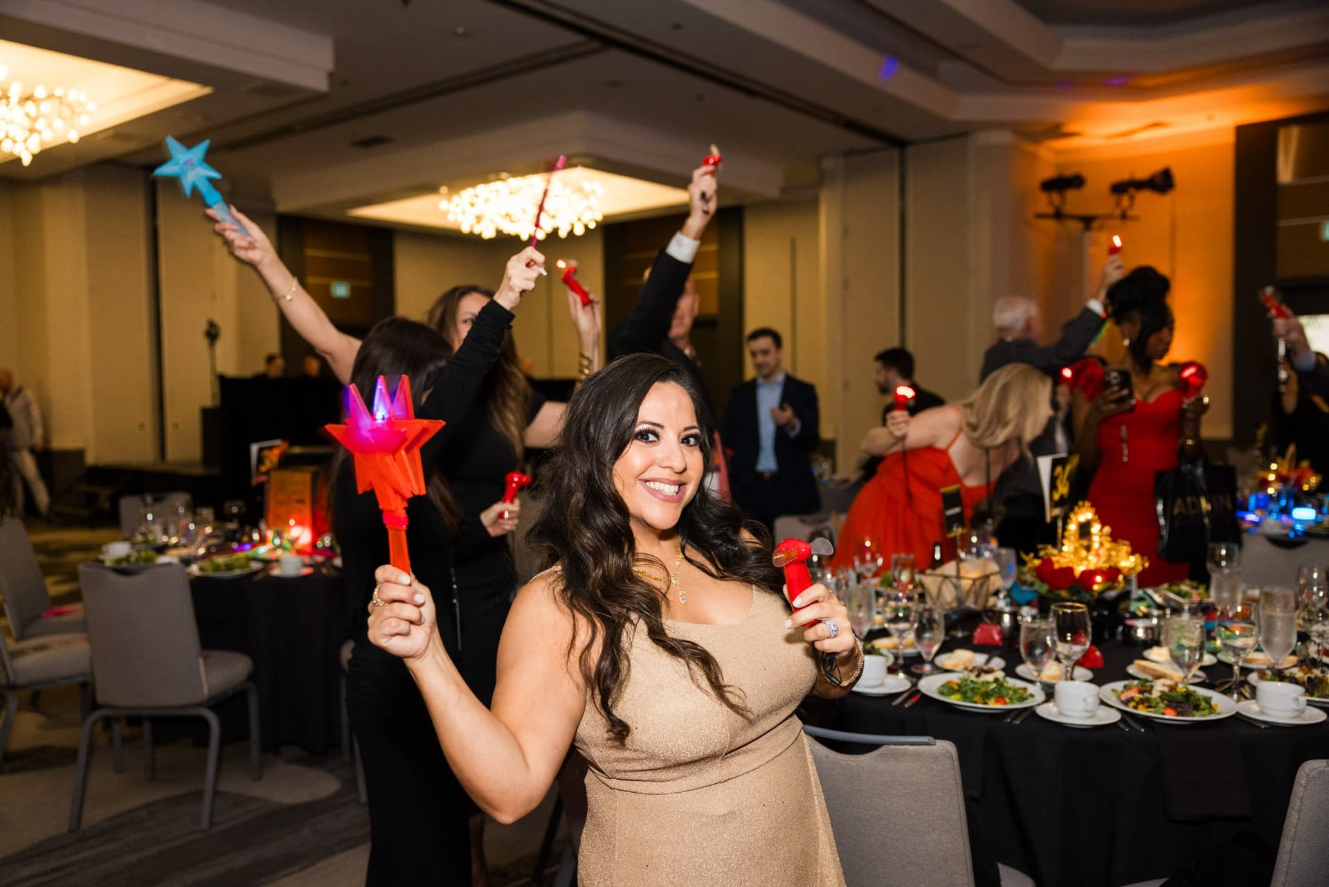 Guest waving a light-up star wand in the ballroom during the gala at Admin Awards 2026 at SFO Marriott Waterfront, Burlingame by JY Studio