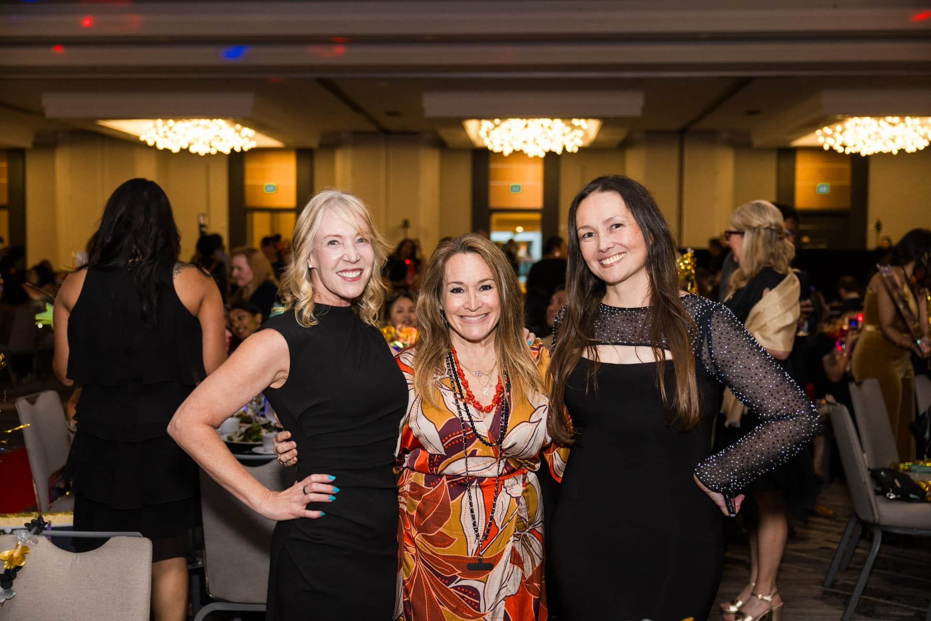 Three guests posing together in the ballroom at Admin Awards 2026 at SFO Marriott Waterfront, Burlingame by JY Studio