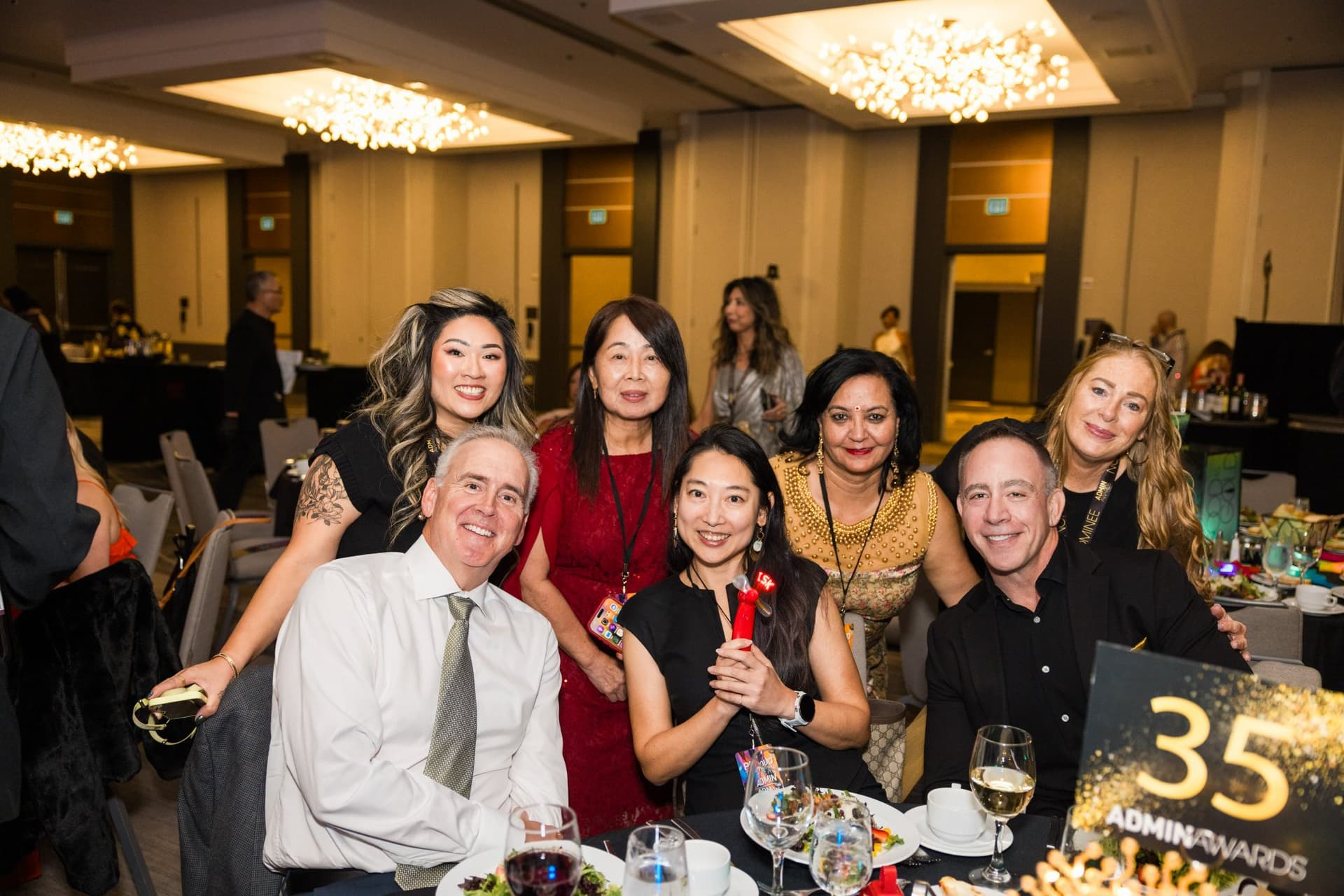 Guests posing together at table 35 in the ballroom at Admin Awards 2026 at SFO Marriott Waterfront, Burlingame by JY Studio