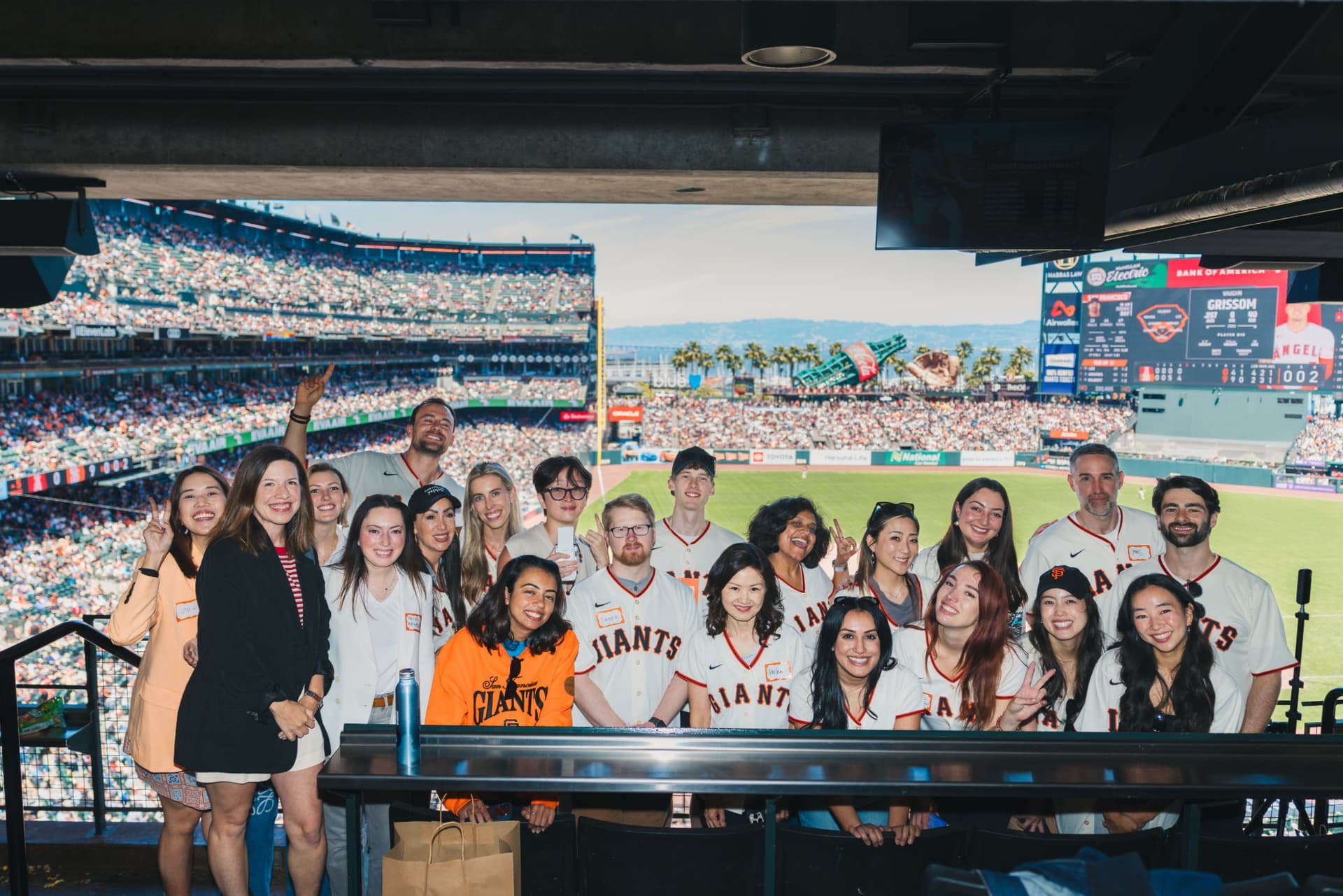 Founders and creators networking inside the Airwallex suite at Oracle Park in San Francisco by JY Studio