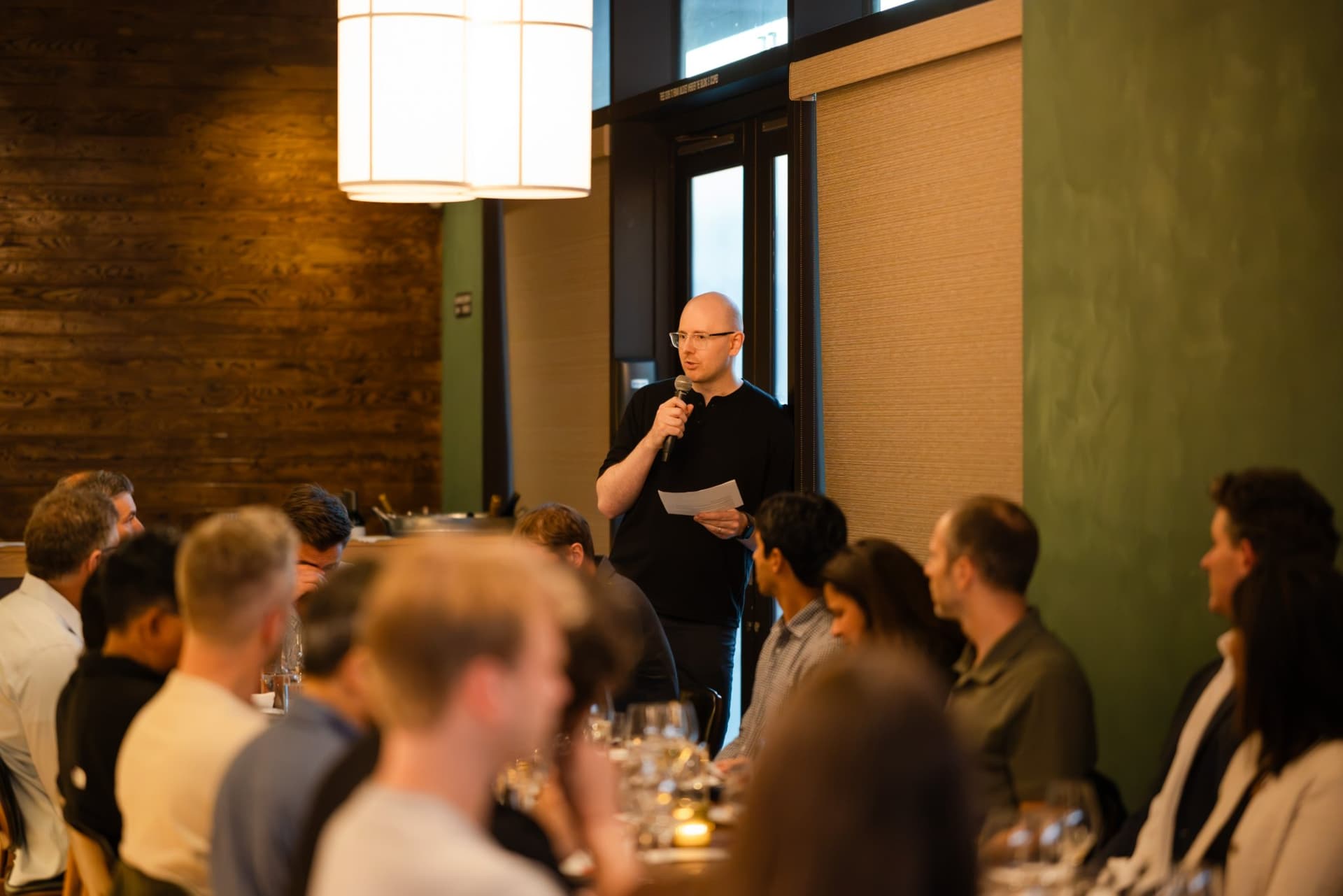 AI Insider host addressing the table of CTOs and tech leaders at the Business Insider AI Insider executive dinner The Great Coding Reset during SF Tech Week 2026 in San Francisco by JY Studio