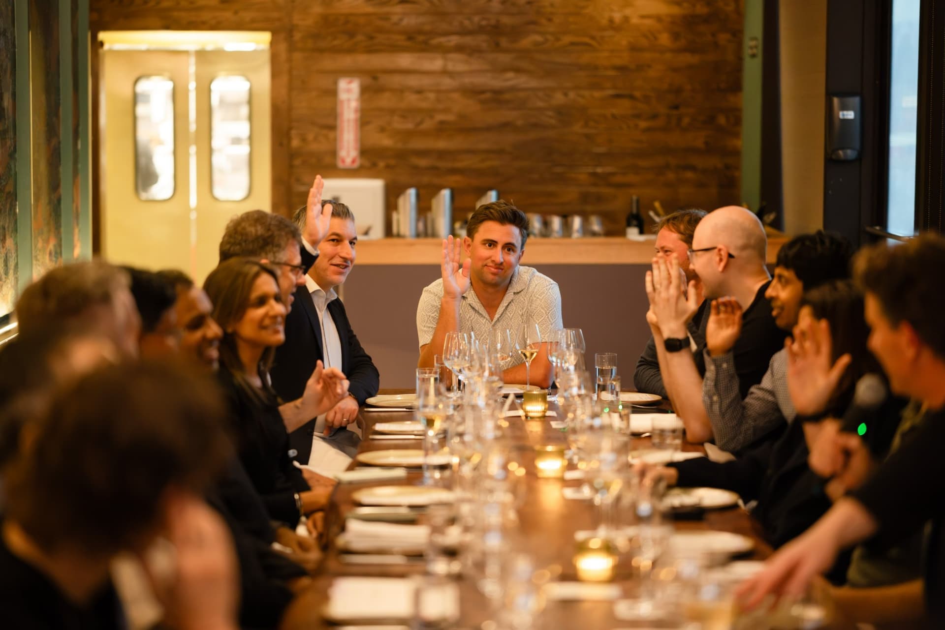 Executives keeping their hands up after being asked who used more than five AI agents at work that day at the Business Insider AI Insider executive dinner The Great Coding Reset during SF Tech Week 2026 in San Francisco by JY Studio