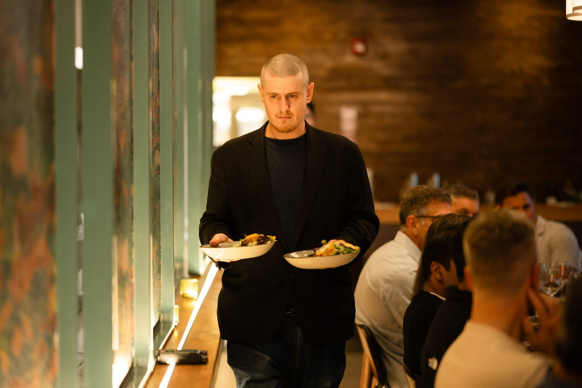 Server carrying plates to the dinner table at the Business Insider AI Insider executive dinner The Great Coding Reset during SF Tech Week 2026 in San Francisco by JY Studio