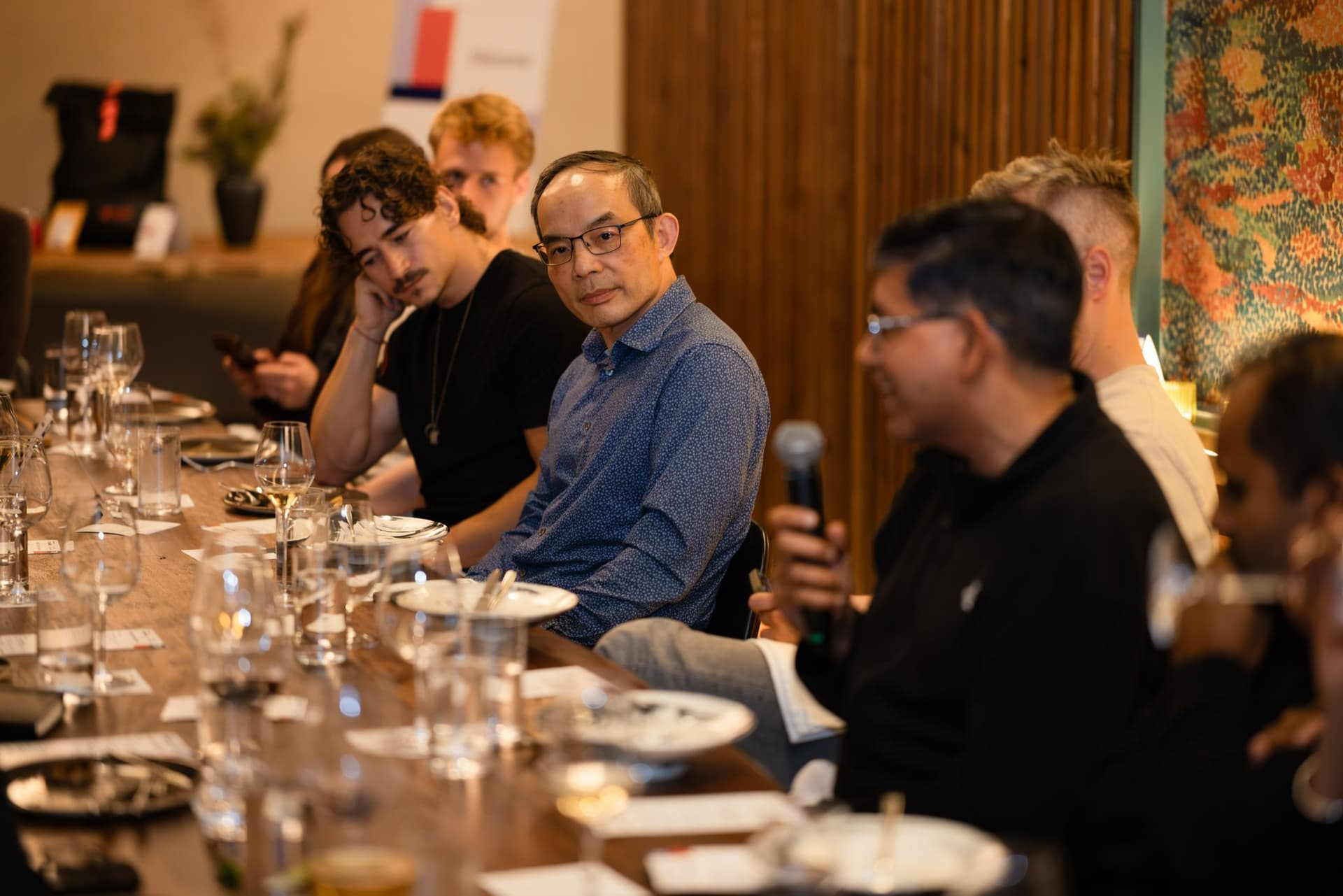 Executive in a blue shirt listening during the discussion at the Business Insider AI Insider executive dinner The Great Coding Reset during SF Tech Week 2026 in San Francisco by JY Studio