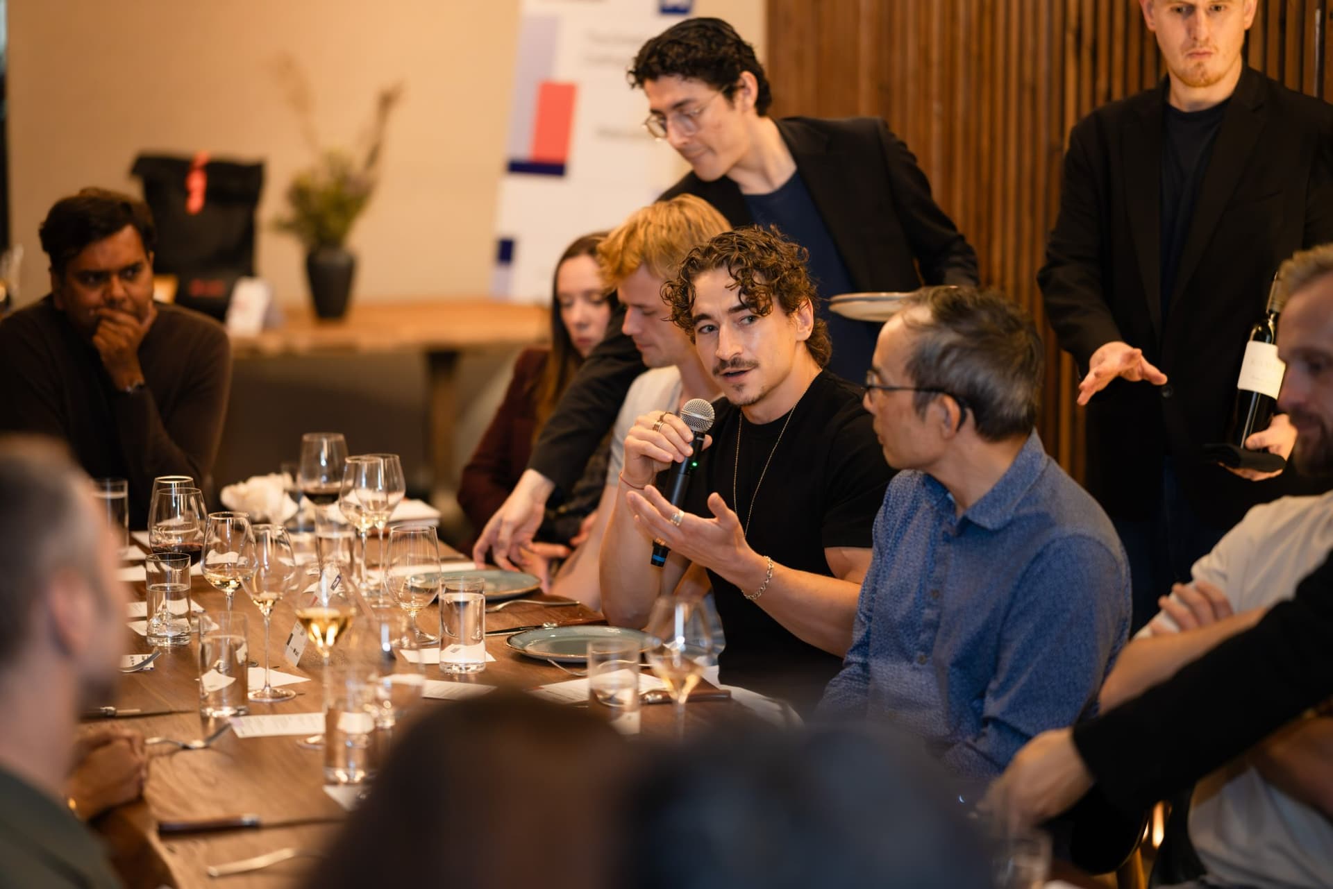 Startup founder gesturing while speaking about AI and hiring engineers at the Business Insider AI Insider executive dinner The Great Coding Reset during SF Tech Week 2026 in San Francisco by JY Studio