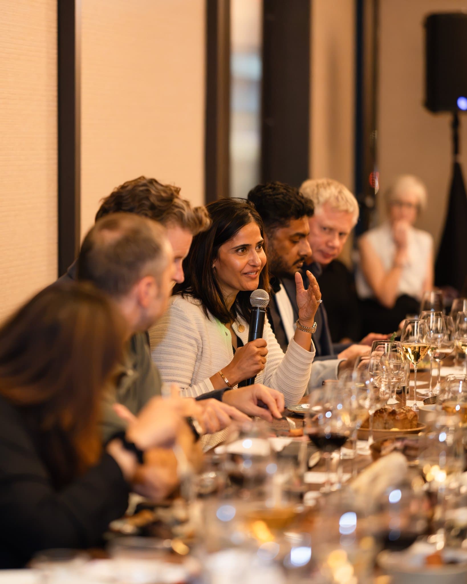 Executive smiling while sharing a story with the table at the Business Insider AI Insider executive dinner The Great Coding Reset during SF Tech Week 2026 in San Francisco by JY Studio