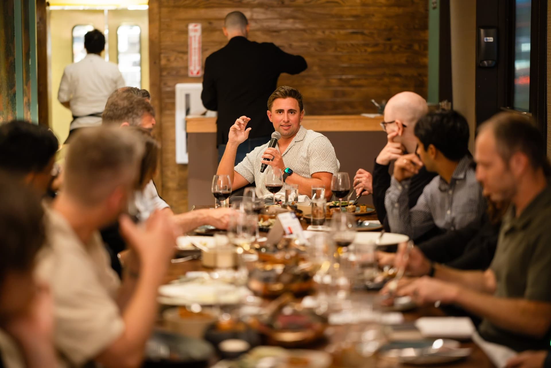Executive speaking from the far end of the long table at the Business Insider AI Insider executive dinner The Great Coding Reset during SF Tech Week 2026 in San Francisco by JY Studio