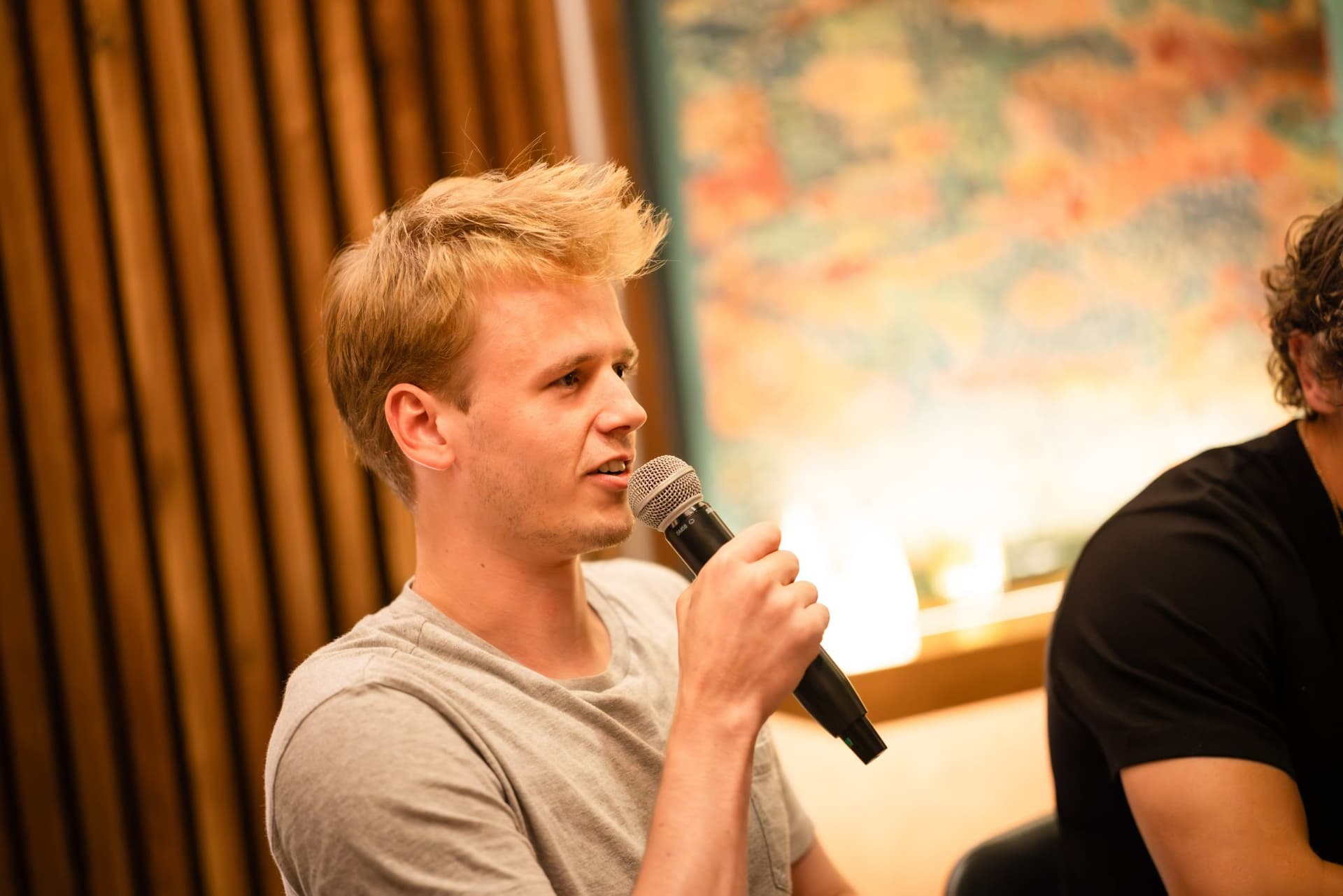 Young tech executive speaking with a microphone at the Business Insider AI Insider executive dinner The Great Coding Reset during SF Tech Week 2026 in San Francisco by JY Studio