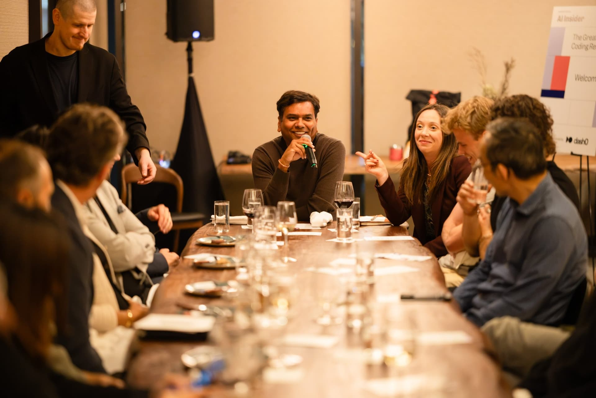 Executive answering the host's question from the end of the table at the Business Insider AI Insider executive dinner The Great Coding Reset during SF Tech Week 2026 in San Francisco by JY Studio