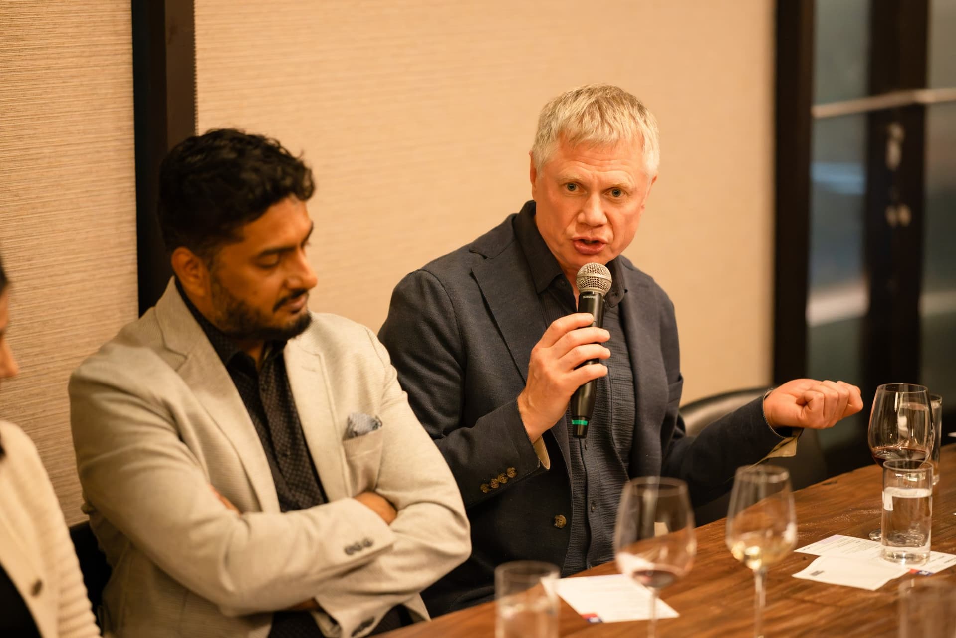 Executive in a navy blazer speaking to the room at the Business Insider AI Insider executive dinner The Great Coding Reset during SF Tech Week 2026 in San Francisco by JY Studio