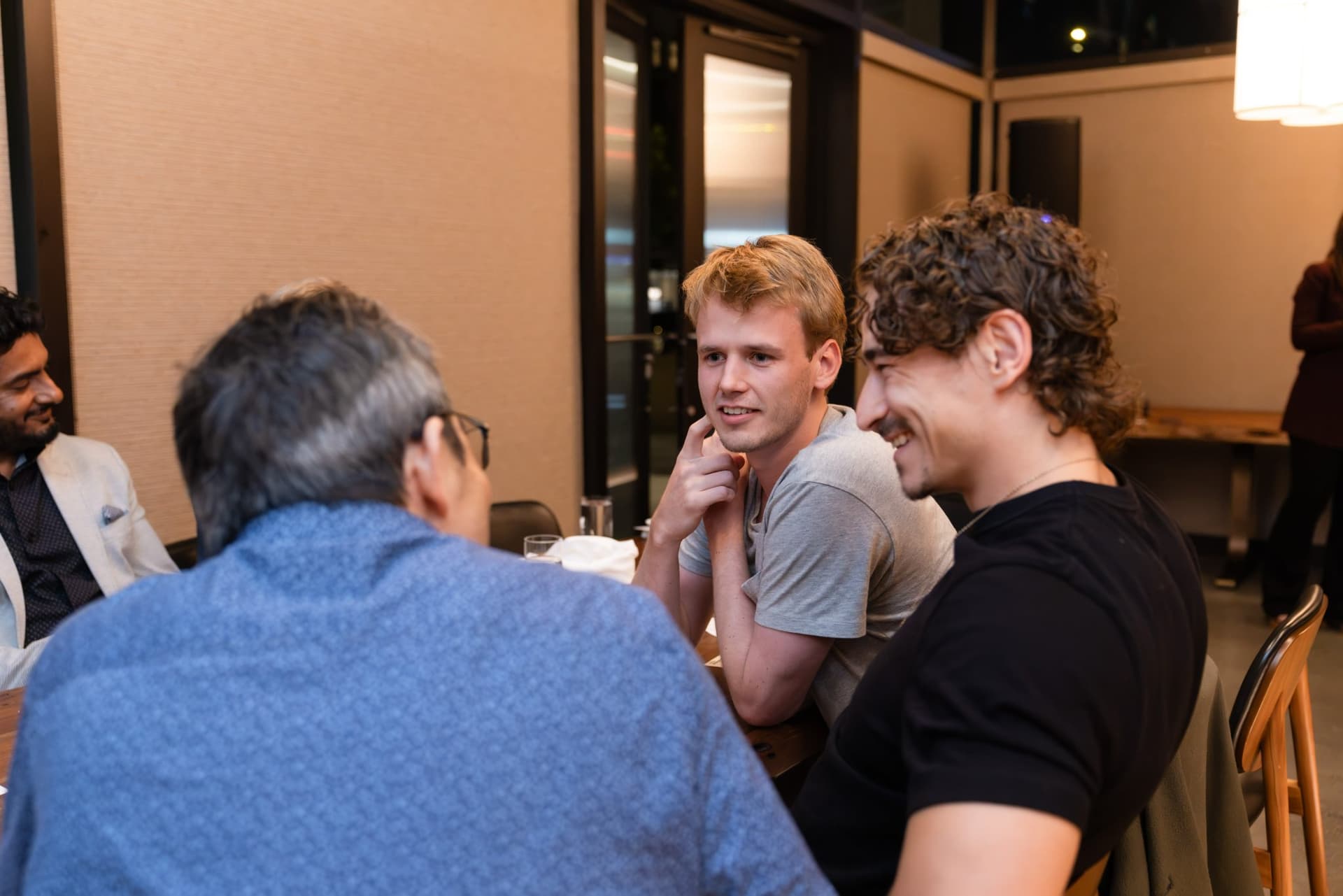 Executives laughing together across the dinner table at the Business Insider AI Insider executive dinner The Great Coding Reset during SF Tech Week 2026 in San Francisco by JY Studio