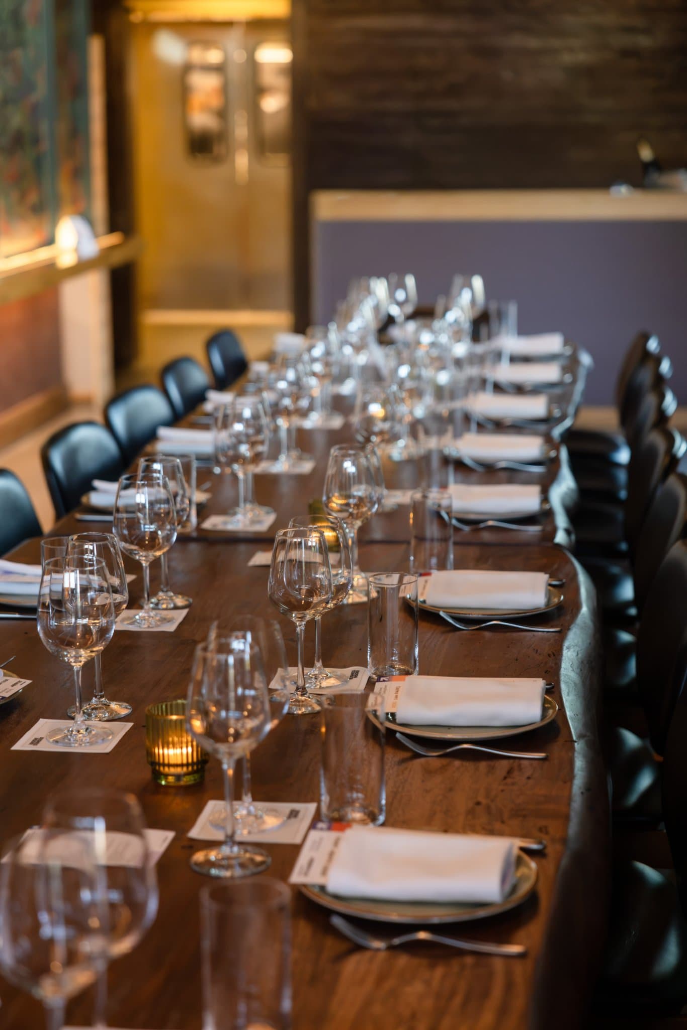 Long table set with wine glasses and candles before guests arrive at the Business Insider AI Insider executive dinner The Great Coding Reset during SF Tech Week 2026 in San Francisco by JY Studio