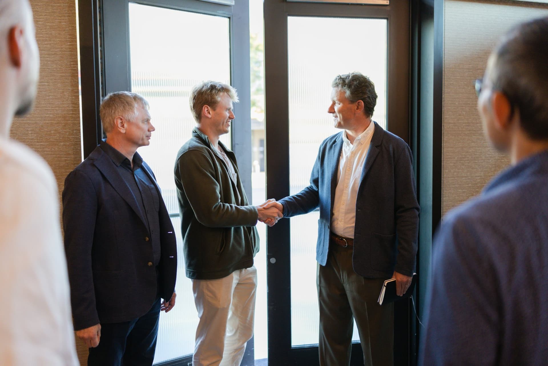 Executives shaking hands as they arrive at the dinner at the Business Insider AI Insider executive dinner The Great Coding Reset during SF Tech Week 2026 in San Francisco by JY Studio