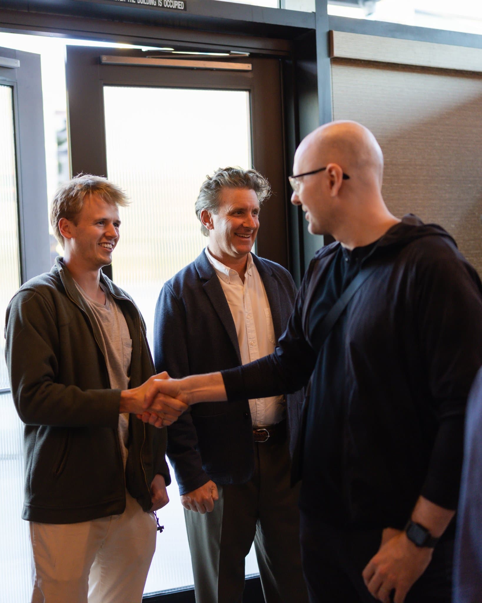AI Insider host greeting arriving executives with a handshake at the Business Insider AI Insider executive dinner The Great Coding Reset during SF Tech Week 2026 in San Francisco by JY Studio