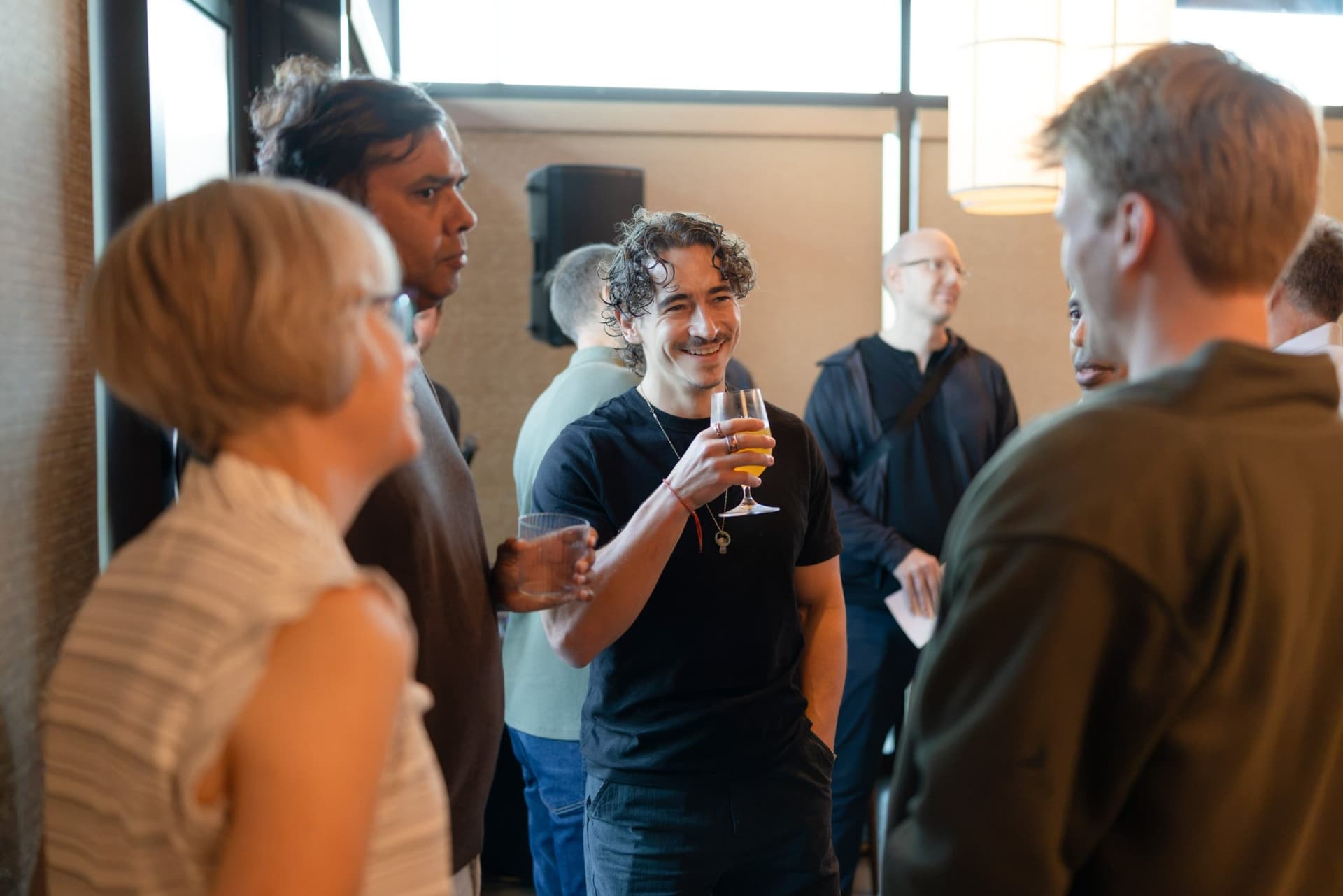 Executive raising a glass while chatting with guests at the Business Insider AI Insider executive dinner The Great Coding Reset during SF Tech Week 2026 in San Francisco by JY Studio
