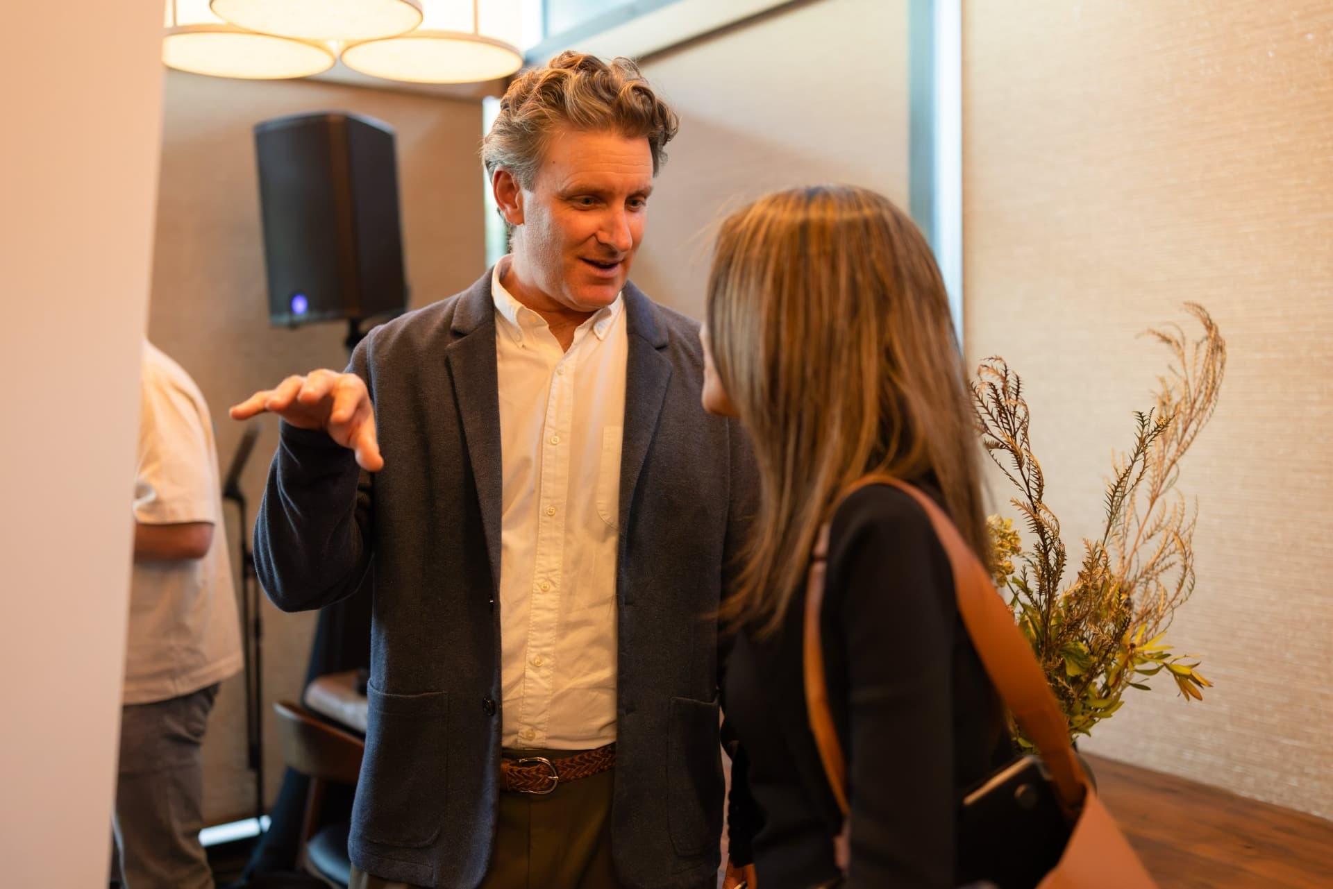 Executive gesturing in conversation during the reception at the Business Insider AI Insider executive dinner The Great Coding Reset during SF Tech Week 2026 in San Francisco by JY Studio