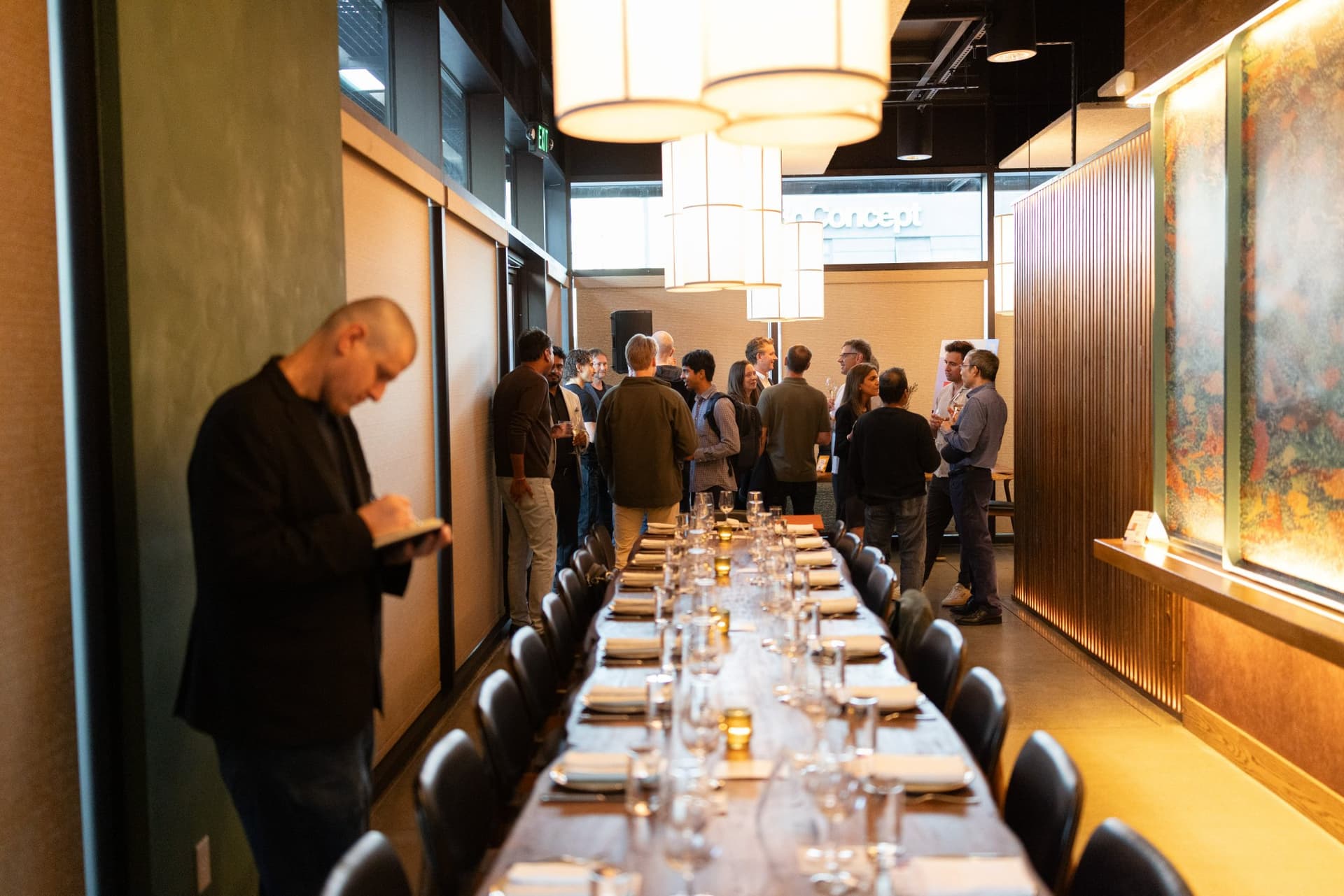 AI Insider host reviewing his notes as guests arrive at the Business Insider AI Insider executive dinner The Great Coding Reset during SF Tech Week 2026 in San Francisco by JY Studio