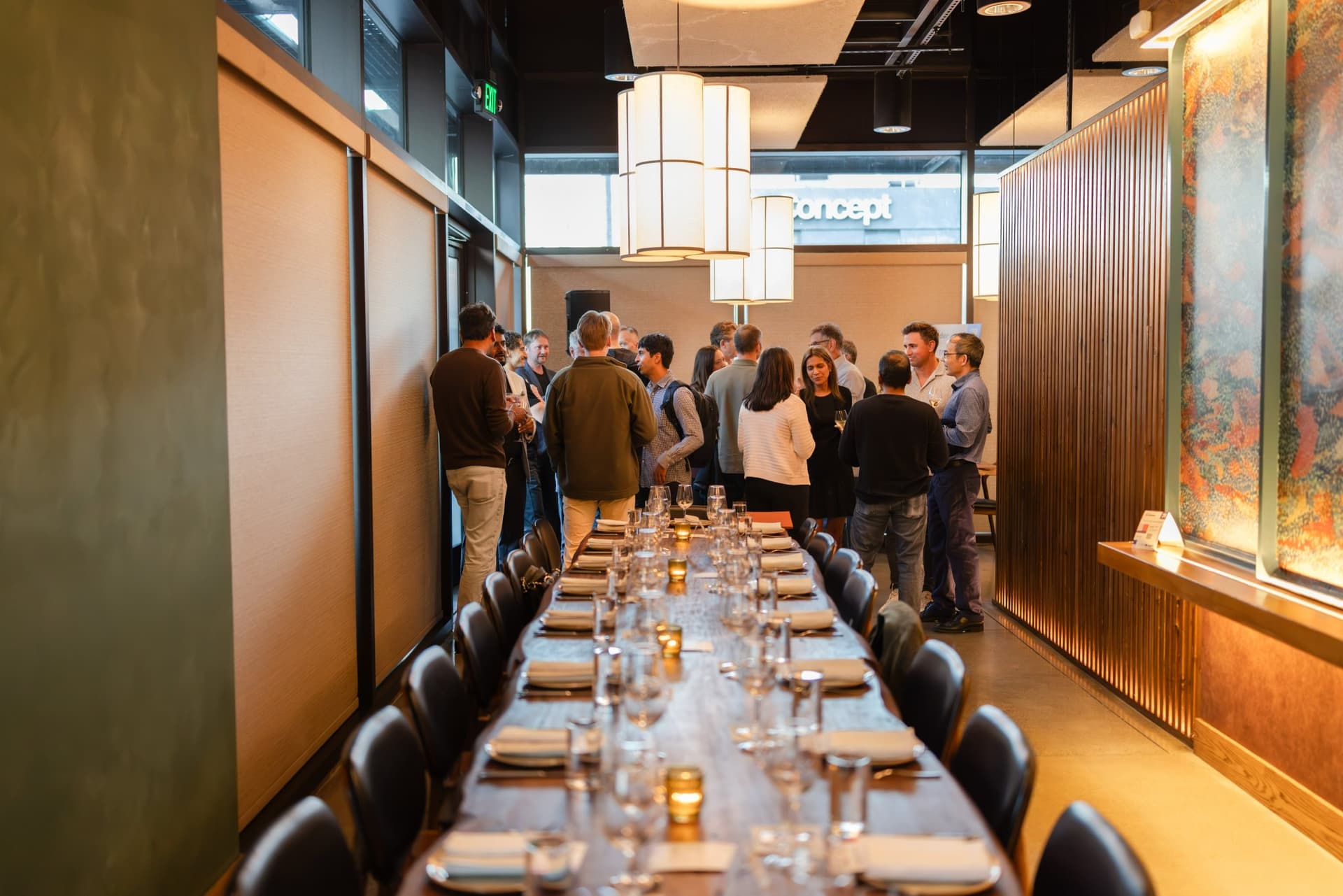 Executives mingling at the far end of the dining room before dinner at the Business Insider AI Insider executive dinner The Great Coding Reset during SF Tech Week 2026 in San Francisco by JY Studio