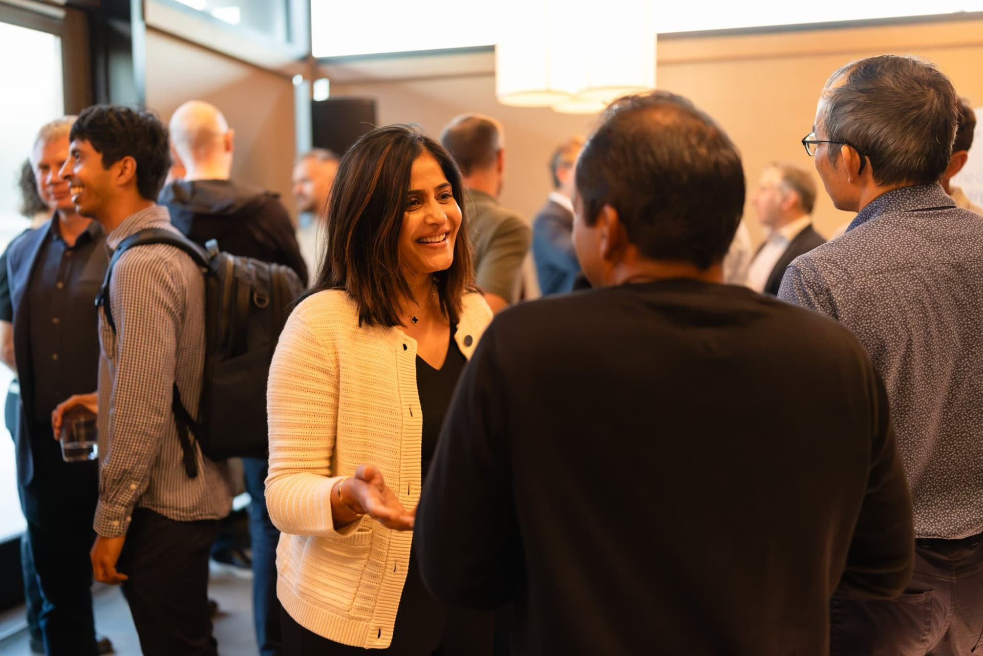 Woman tech executive laughing with guests during the reception at the Business Insider AI Insider executive dinner The Great Coding Reset during SF Tech Week 2026 in San Francisco by JY Studio