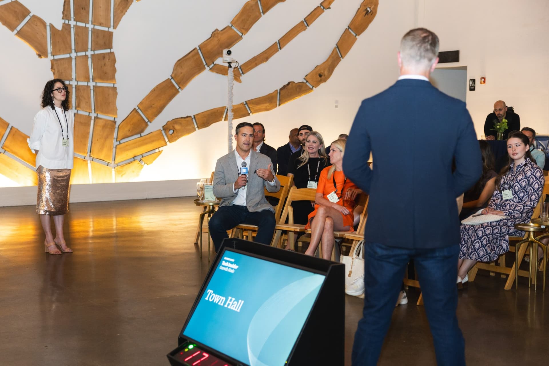 Attendee asking a question during the Town Hall as the host listens at Business Insider Tech Insider: Growth Mode at The Pearl SF during SF Tech Week 2026 in San Francisco by JY Studio