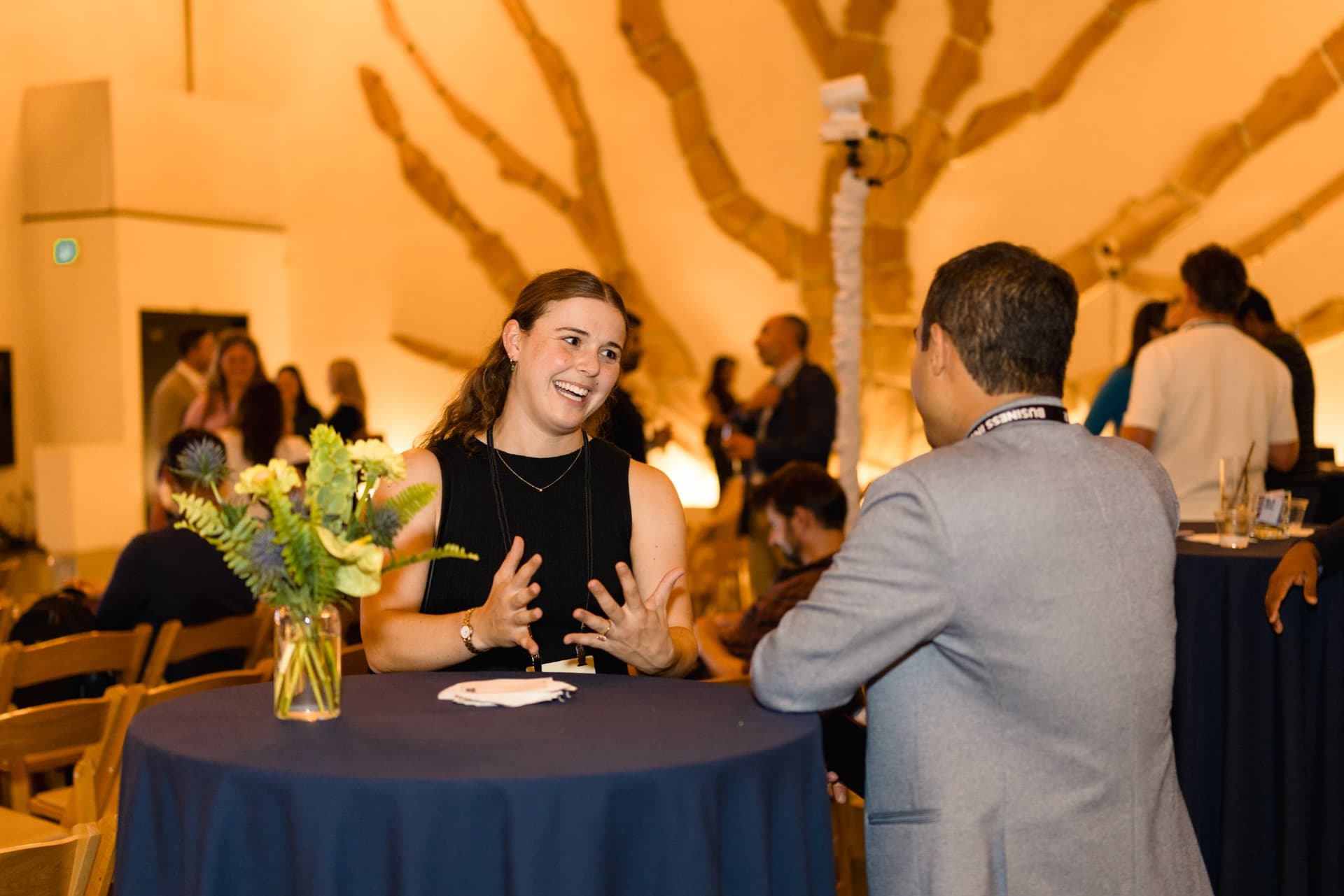 Attendee smiling while talking at a cocktail table at Business Insider Tech Insider: Growth Mode at The Pearl SF during SF Tech Week 2026 in San Francisco by JY Studio
