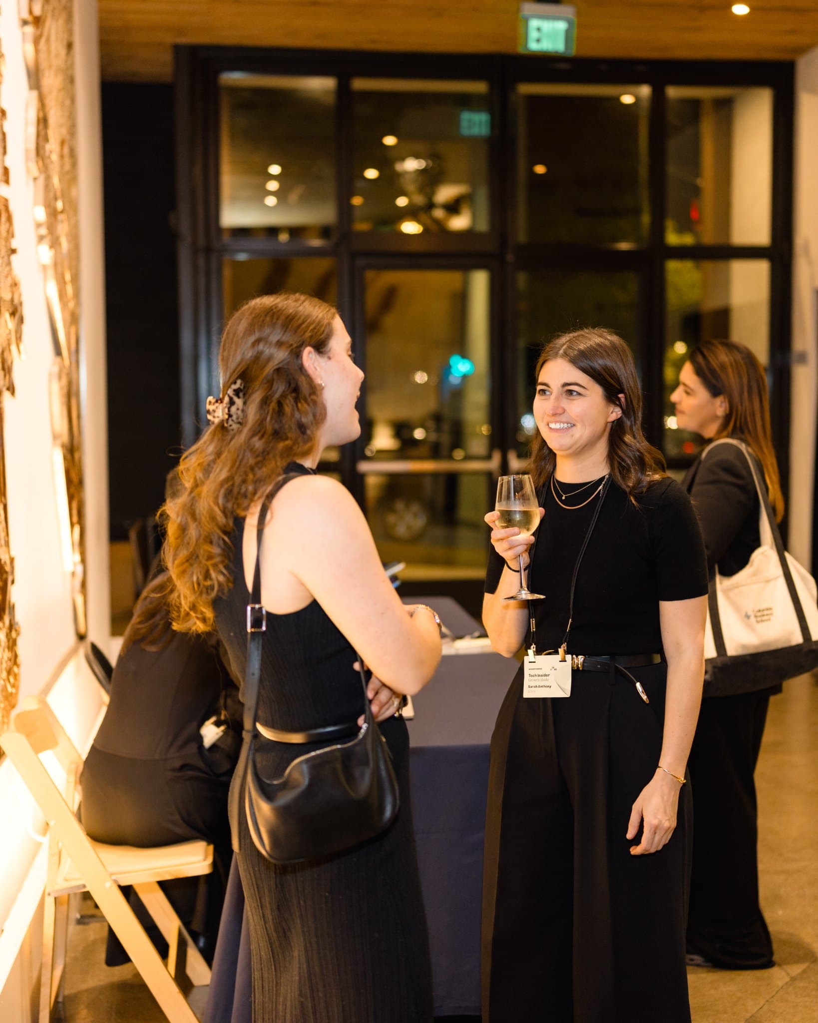 Two attendees talking by the bar at Business Insider Tech Insider: Growth Mode at The Pearl SF during SF Tech Week 2026 in San Francisco by JY Studio