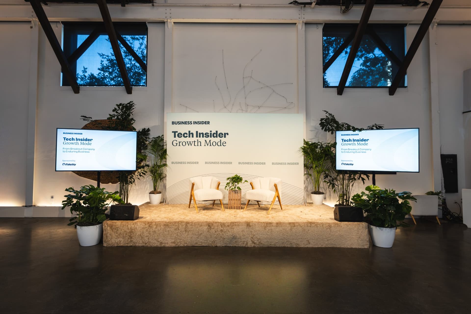 Empty stage at The Pearl SF main hall set for Business Insider Tech Insider: Growth Mode with lounge chairs and screens, photographed by JY Studio