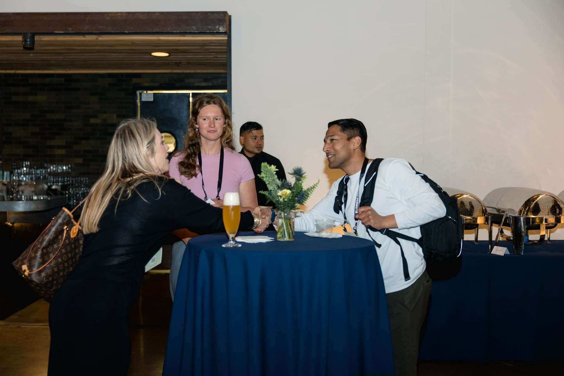 Guests chatting at a cocktail table by the bar at Business Insider Tech Insider: Growth Mode at The Pearl SF during SF Tech Week 2026 in San Francisco by JY Studio