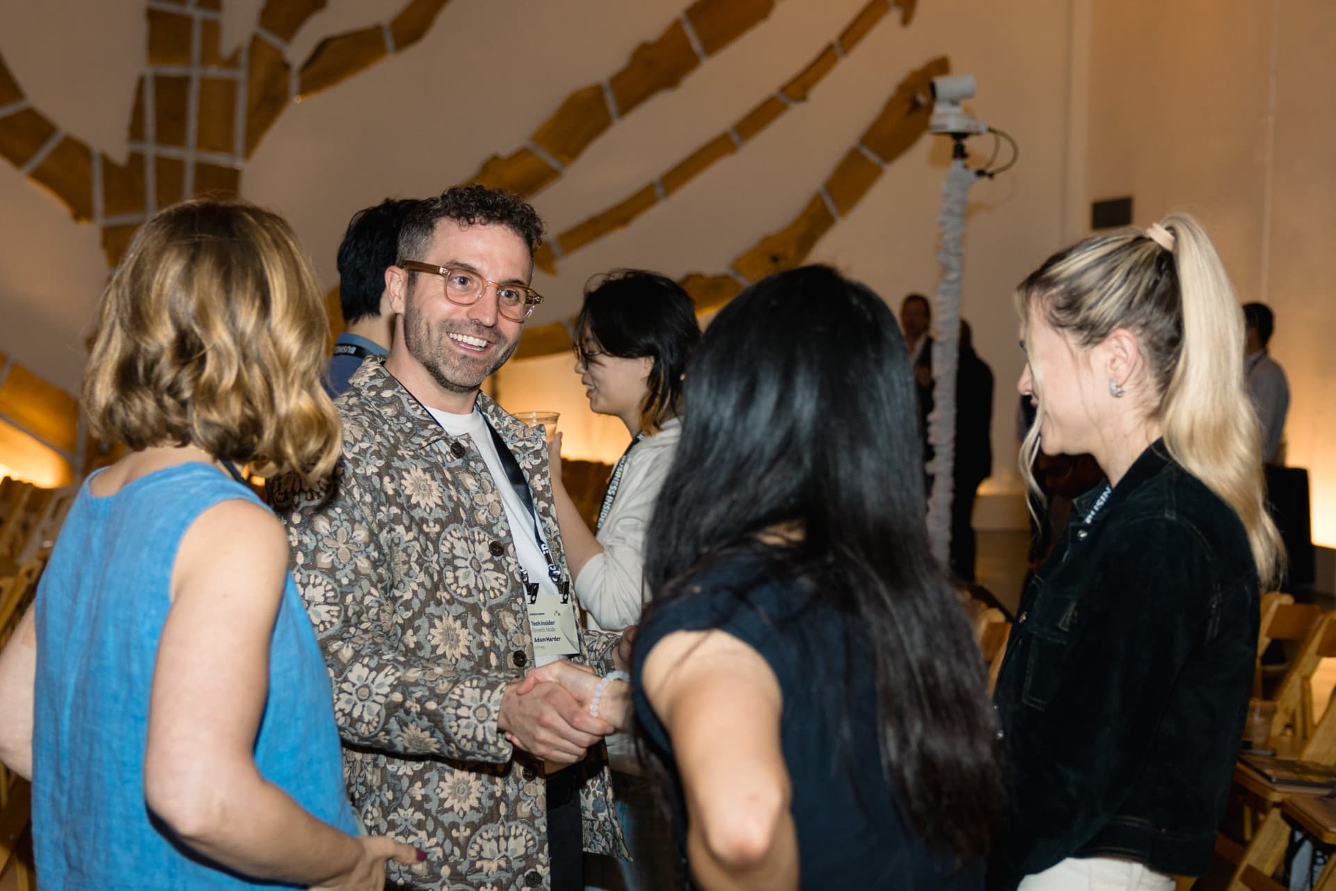 Attendees greeting each other in the crowd at Business Insider Tech Insider: Growth Mode at The Pearl SF during SF Tech Week 2026 in San Francisco by JY Studio