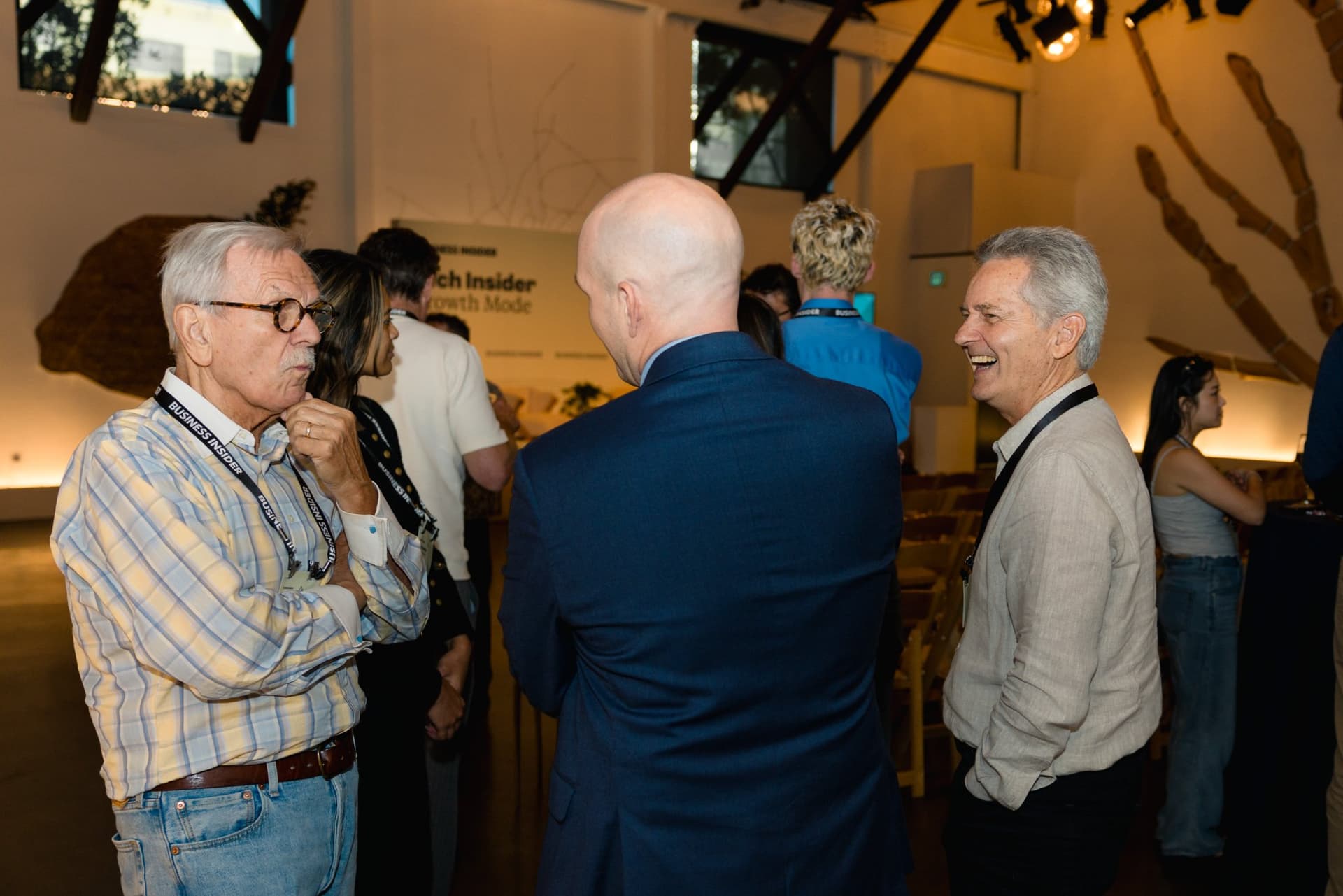 Two attendees laughing during the reception at Business Insider Tech Insider: Growth Mode at The Pearl SF during SF Tech Week 2026 in San Francisco by JY Studio