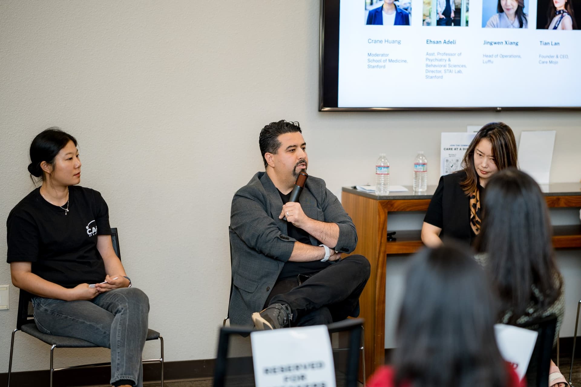 Panelists listening and taking notes during Panel 1 "Sensing Wellbeing from a Distance" at Care at a Distance: AI, Sensors, Robotics and the Future of Aging, SF Tech Week 2026 at EVGR, Stanford University by JY Studio