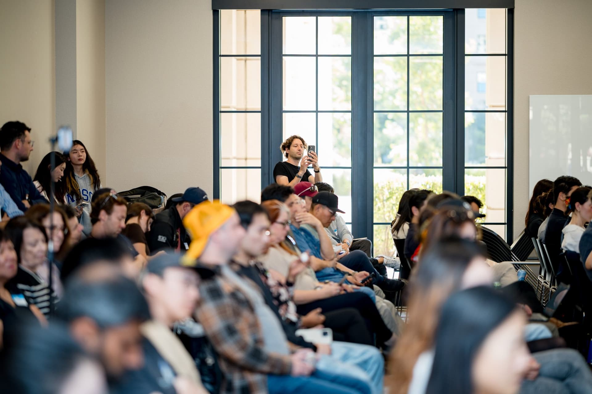Packed audience of founders, researchers, and caregivers listening to the panel at Care at a Distance: AI, Sensors, Robotics and the Future of Aging, SF Tech Week 2026 at EVGR, Stanford University by JY Studio