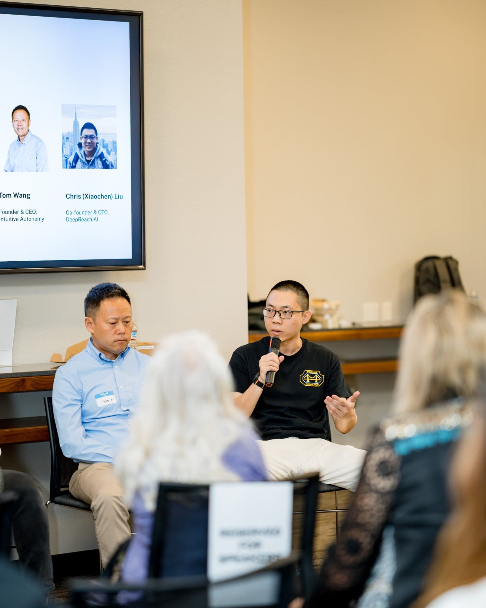 Vertical shot of a robotics founder speaking during Panel 2 "Robotics for Independent Living" at Care at a Distance: AI, Sensors, Robotics and the Future of Aging, SF Tech Week 2026 at EVGR, Stanford University by JY Studio