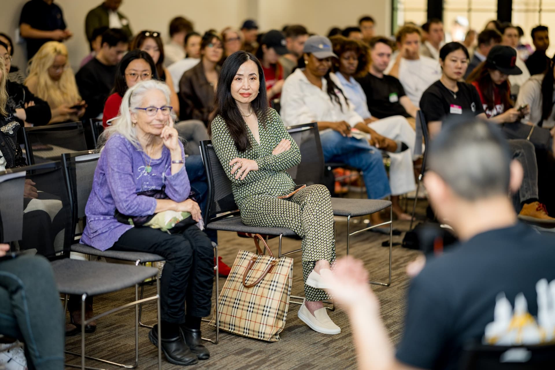 Attendees listening intently in the front row during the robotics panel at Care at a Distance: AI, Sensors, Robotics and the Future of Aging, SF Tech Week 2026 at EVGR, Stanford University by JY Studio
