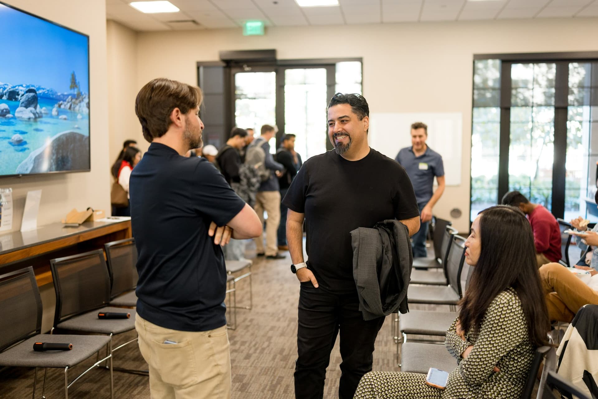 Attendees chatting before the program starts at Care at a Distance: AI, Sensors, Robotics and the Future of Aging, SF Tech Week 2026 at EVGR, Stanford University by JY Studio