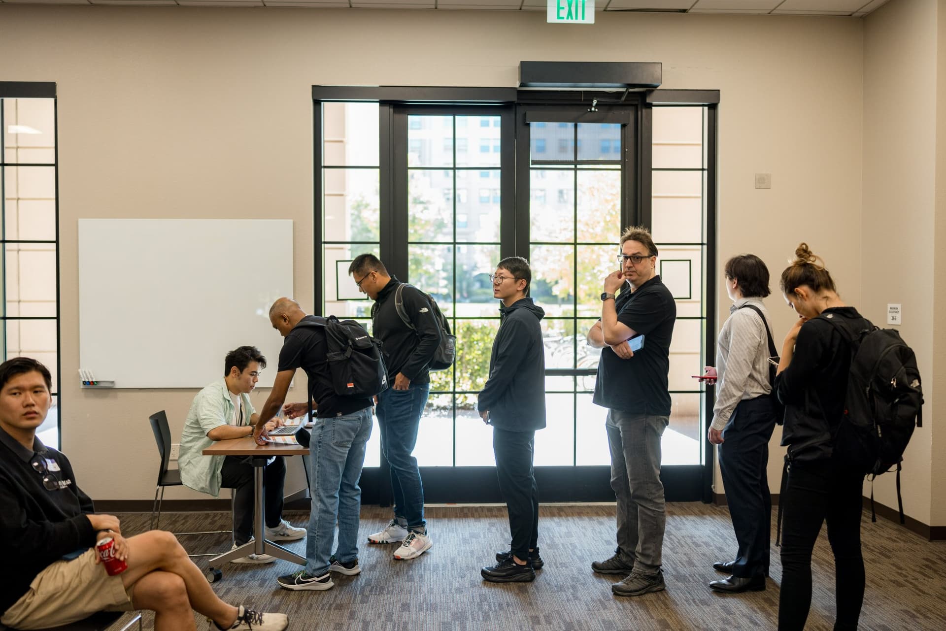 Line of attendees arriving and checking in at the event at Care at a Distance: AI, Sensors, Robotics and the Future of Aging, SF Tech Week 2026 at EVGR, Stanford University by JY Studio