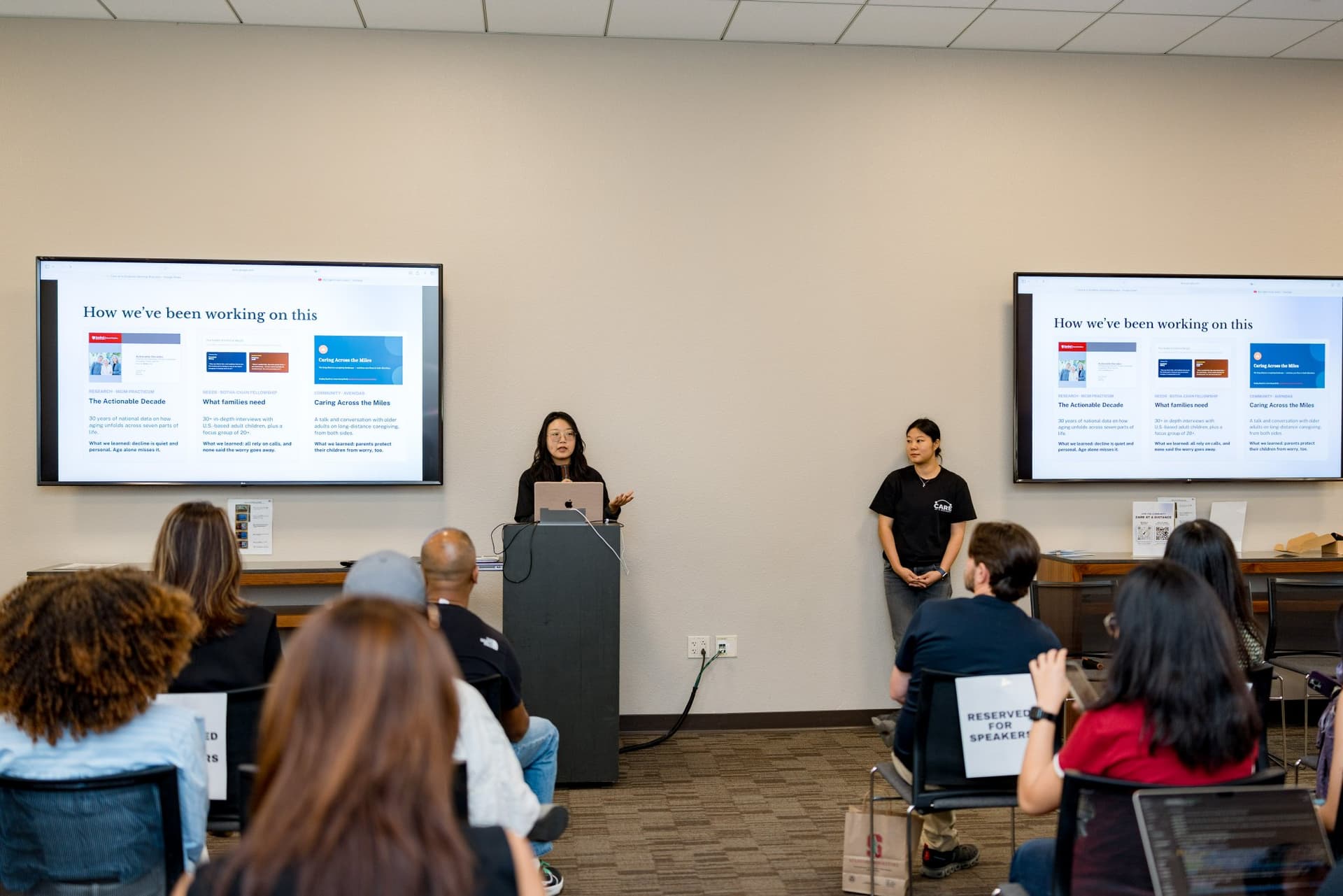 Hosts opening the event with the "How we've been working on this" slides at Care at a Distance: AI, Sensors, Robotics and the Future of Aging, SF Tech Week 2026 at EVGR, Stanford University by JY Studio