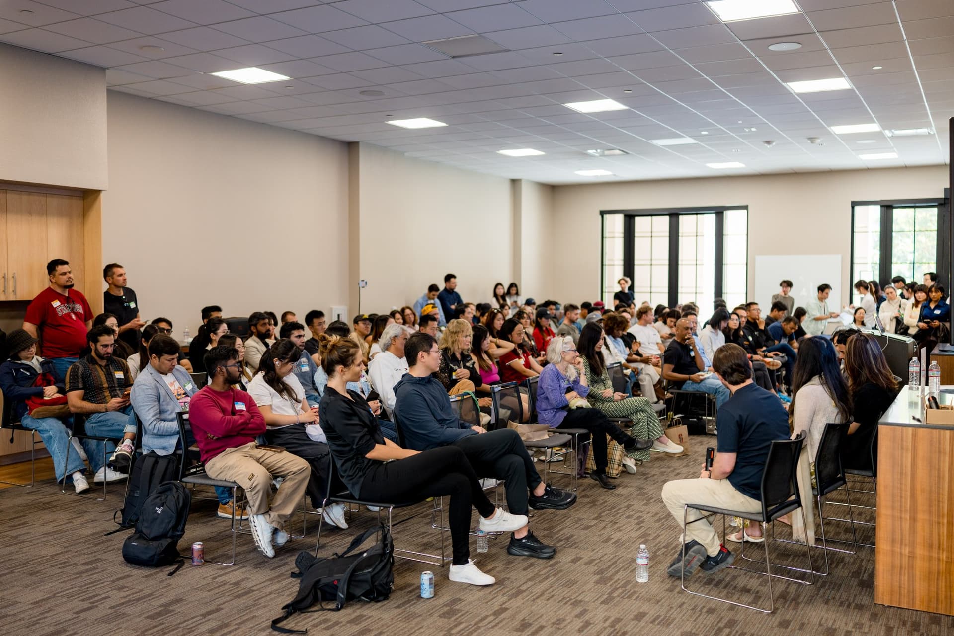 Wide view of the full room of attendees at Care at a Distance: AI, Sensors, Robotics and the Future of Aging, SF Tech Week 2026 at EVGR, Stanford University by JY Studio