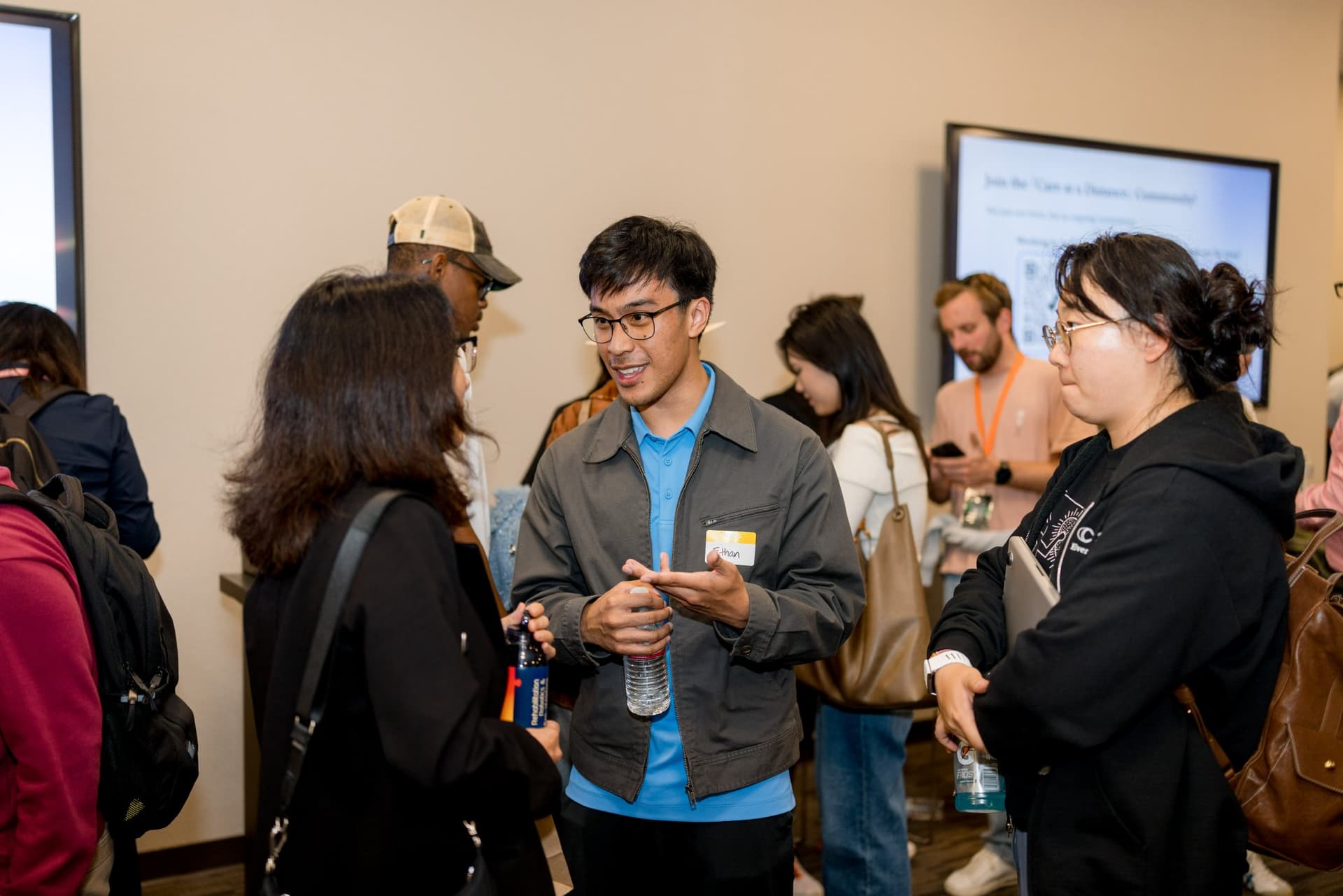 Small groups of attendees networking after the panels at Care at a Distance: AI, Sensors, Robotics and the Future of Aging, SF Tech Week 2026 at EVGR, Stanford University by JY Studio