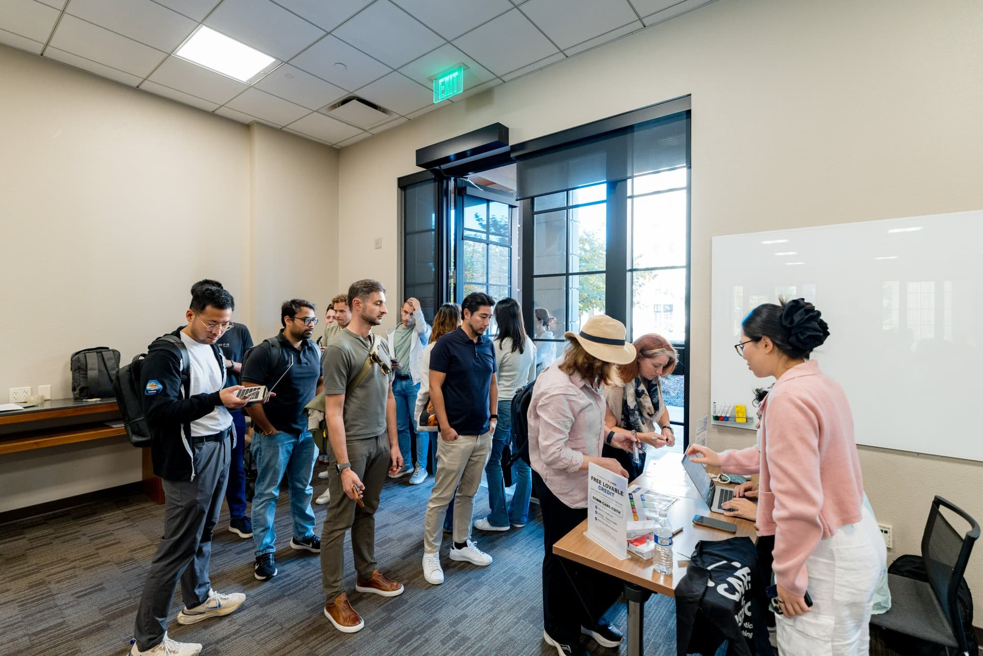 Guests gathering at the registration table during networking at Care at a Distance: AI, Sensors, Robotics and the Future of Aging, SF Tech Week 2026 at EVGR, Stanford University by JY Studio
