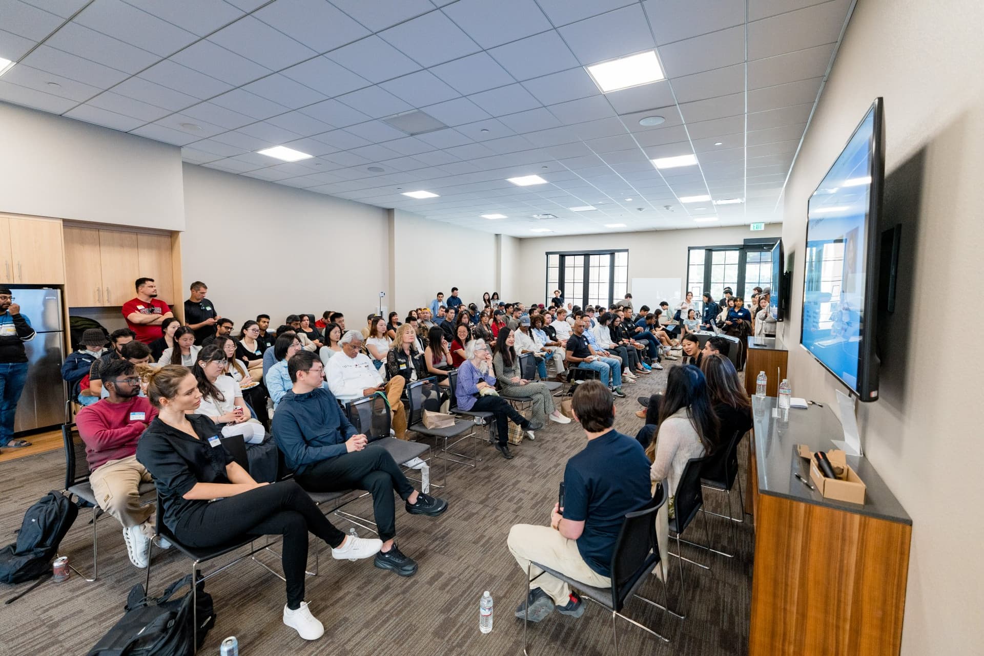 Wide view of the room during the robotics panel at Care at a Distance: AI, Sensors, Robotics and the Future of Aging, SF Tech Week 2026 at EVGR, Stanford University by JY Studio