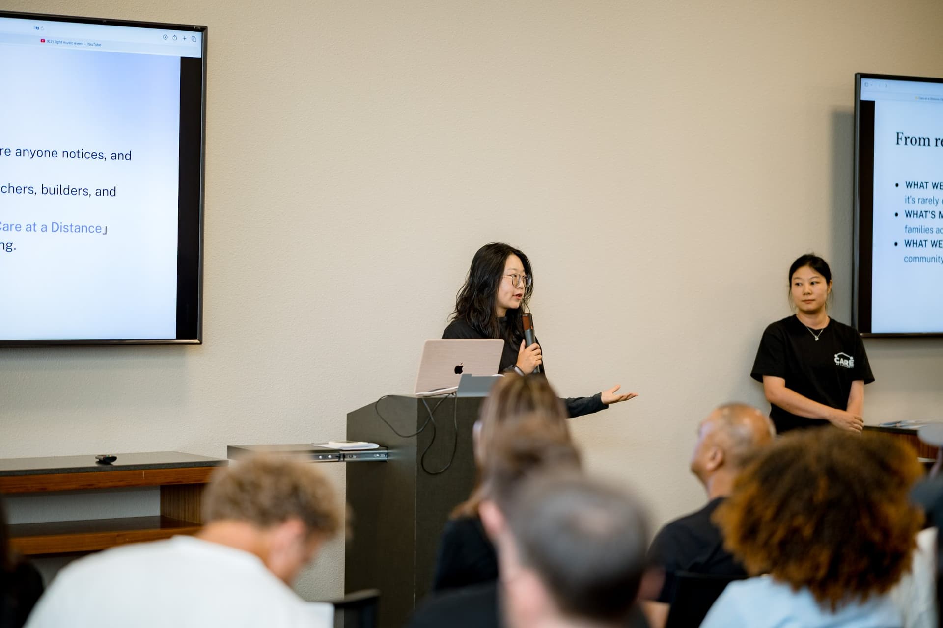 Host inviting attendees to join the Care at a Distance community at the closing at Care at a Distance: AI, Sensors, Robotics and the Future of Aging, SF Tech Week 2026 at EVGR, Stanford University by JY Studio
