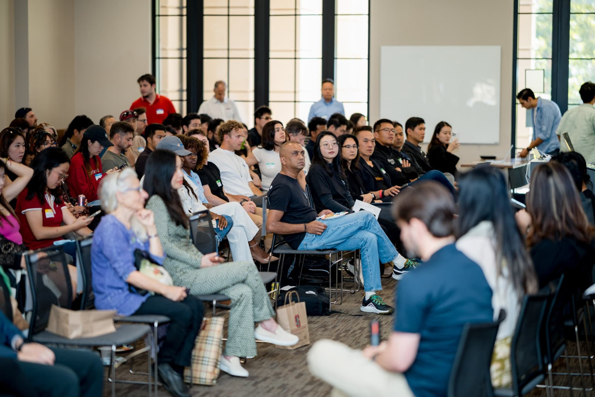 Wide view of attendees listening during the panel at Care at a Distance: AI, Sensors, Robotics and the Future of Aging, SF Tech Week 2026 at EVGR, Stanford University by JY Studio