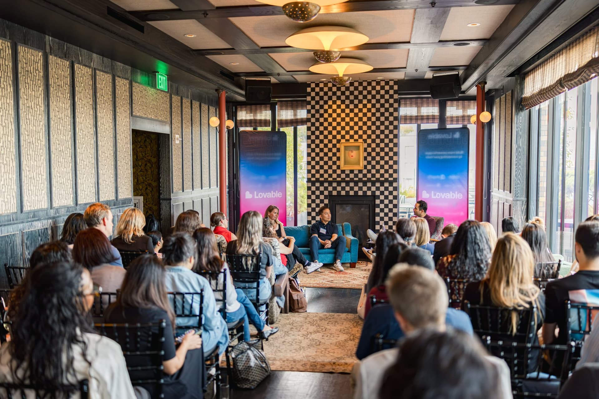 Wide view of the seated audience facing the panel stage at Lovable's When Everyone Can Build panel in San Francisco by JY Studio