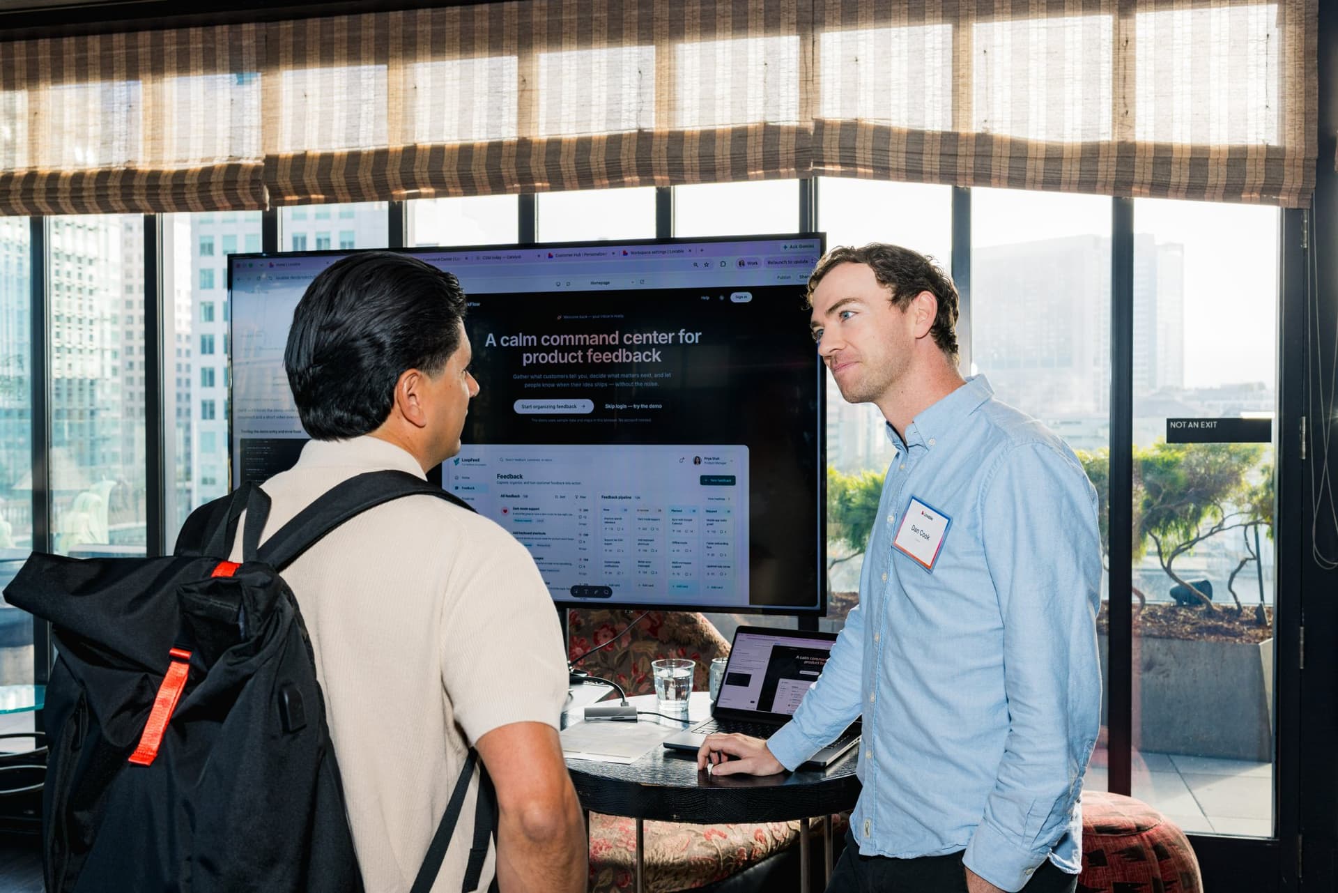 Guests checking out a product demo on screen during the reception at Lovable's When Everyone Can Build panel in San Francisco by JY Studio