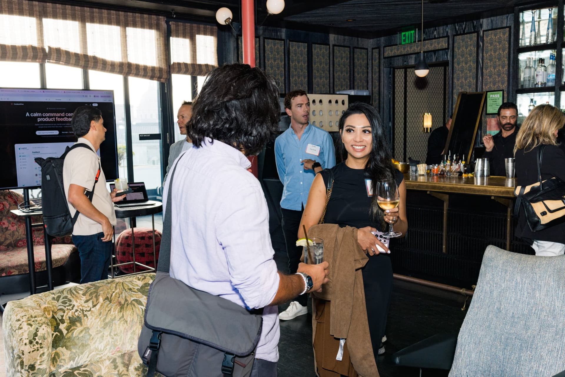 Guests arriving at the bar with drinks before the panel at Lovable's When Everyone Can Build panel in San Francisco by JY Studio