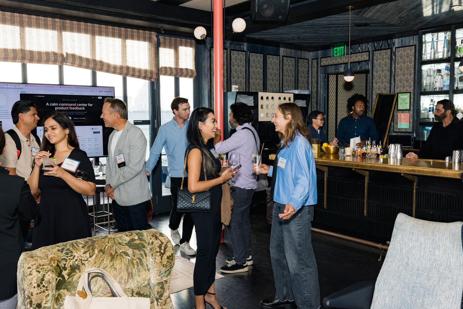 Guests mingling around the bar during the networking reception at Lovable's When Everyone Can Build panel in San Francisco by JY Studio