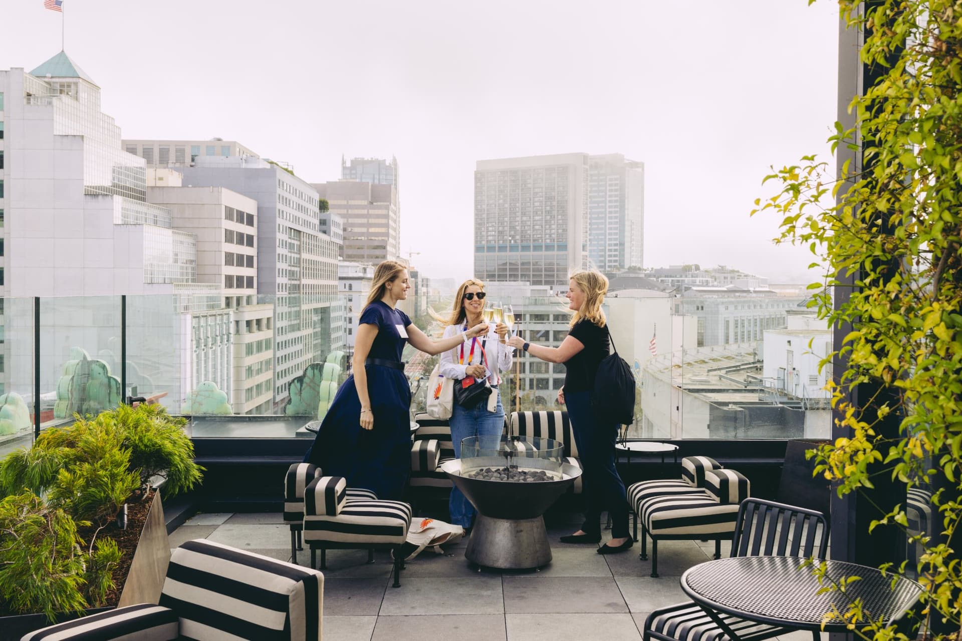 Guests chatting on the outdoor rooftop terrace overlooking the San Francisco skyline at Lovable's When Everyone Can Build panel in San Francisco by JY Studio