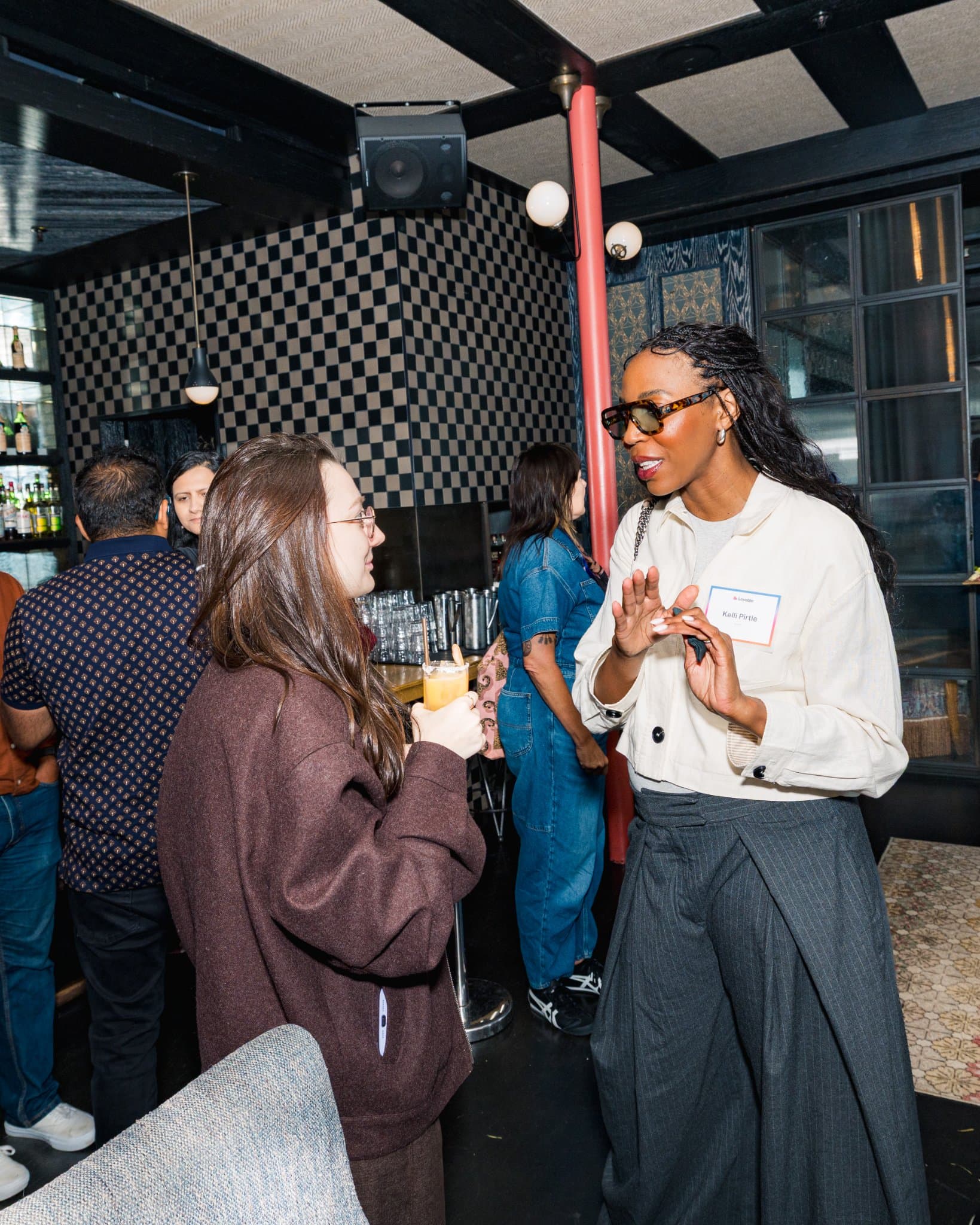 Guest gesturing mid-conversation during the reception at Lovable's When Everyone Can Build panel in San Francisco by JY Studio